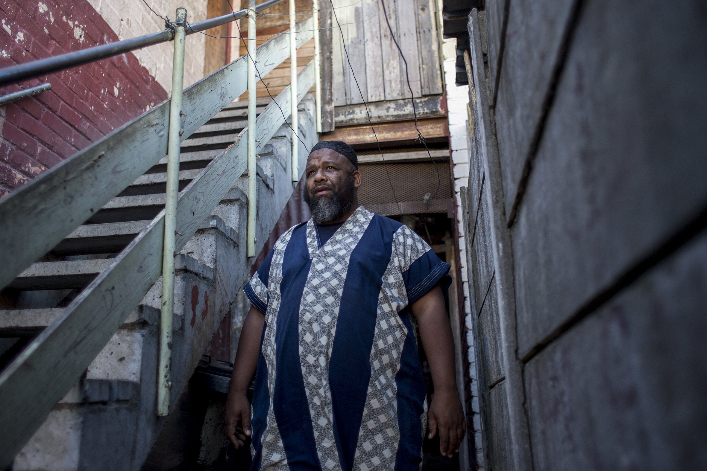 Rashaad Allen walks through an alley in Parkwood. Allen is an ex Ugly Americans gang member who after more than 20 years in prison turned his life around and is now a child care worker at the Ottery Youth Care Centre. April 2017