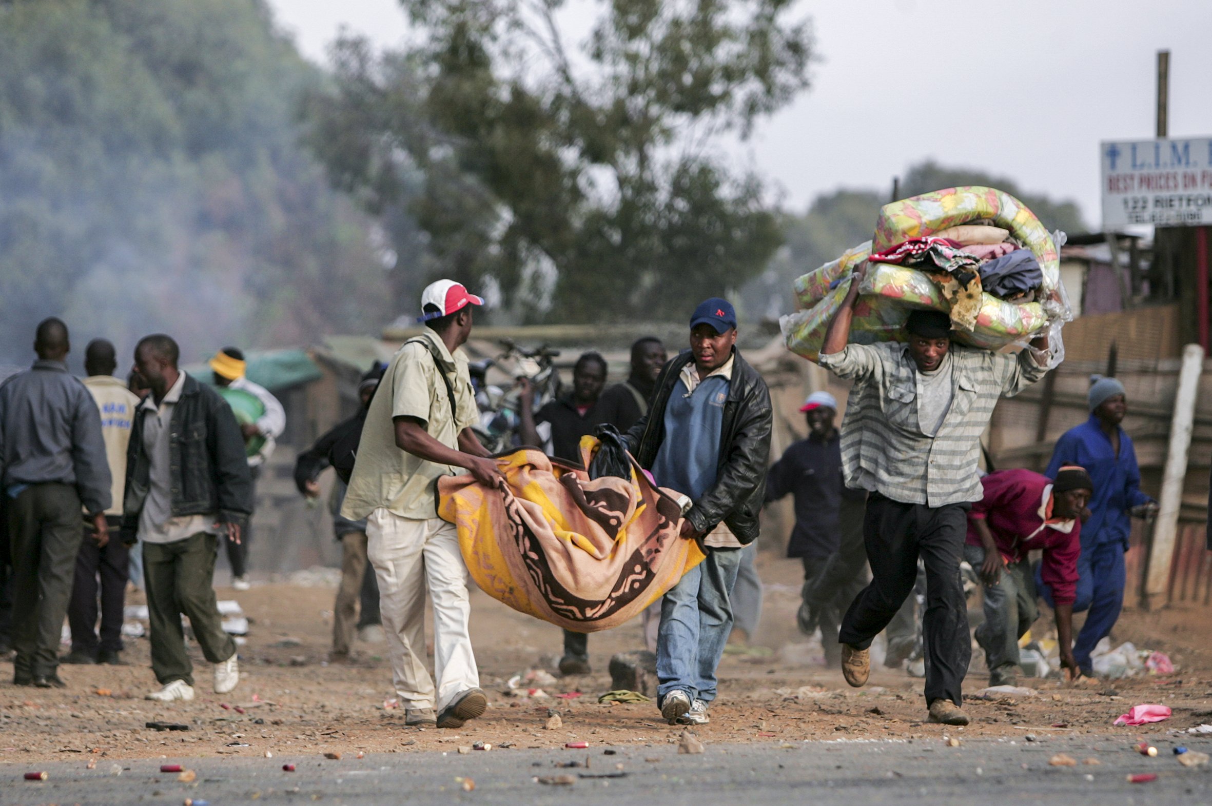 Foreigners flee locals during clashes between the police, foreigners and local residents. Makausi, east of Johannesburg, South Africa.