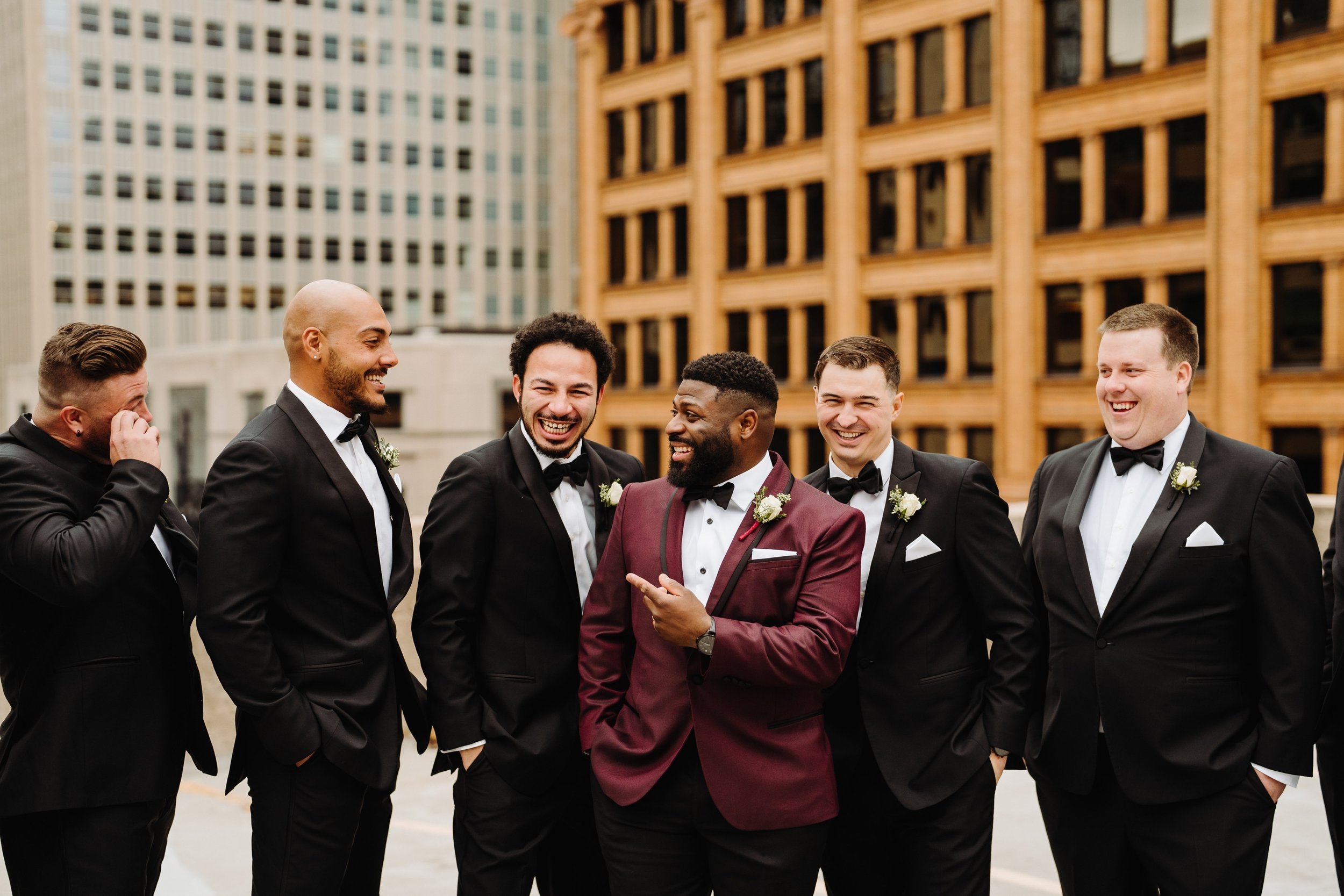050_Groom and groomsmen in black and Burgundy tuxedos in downtown Minneapolis, Minnesota on a parking ramp..jpg