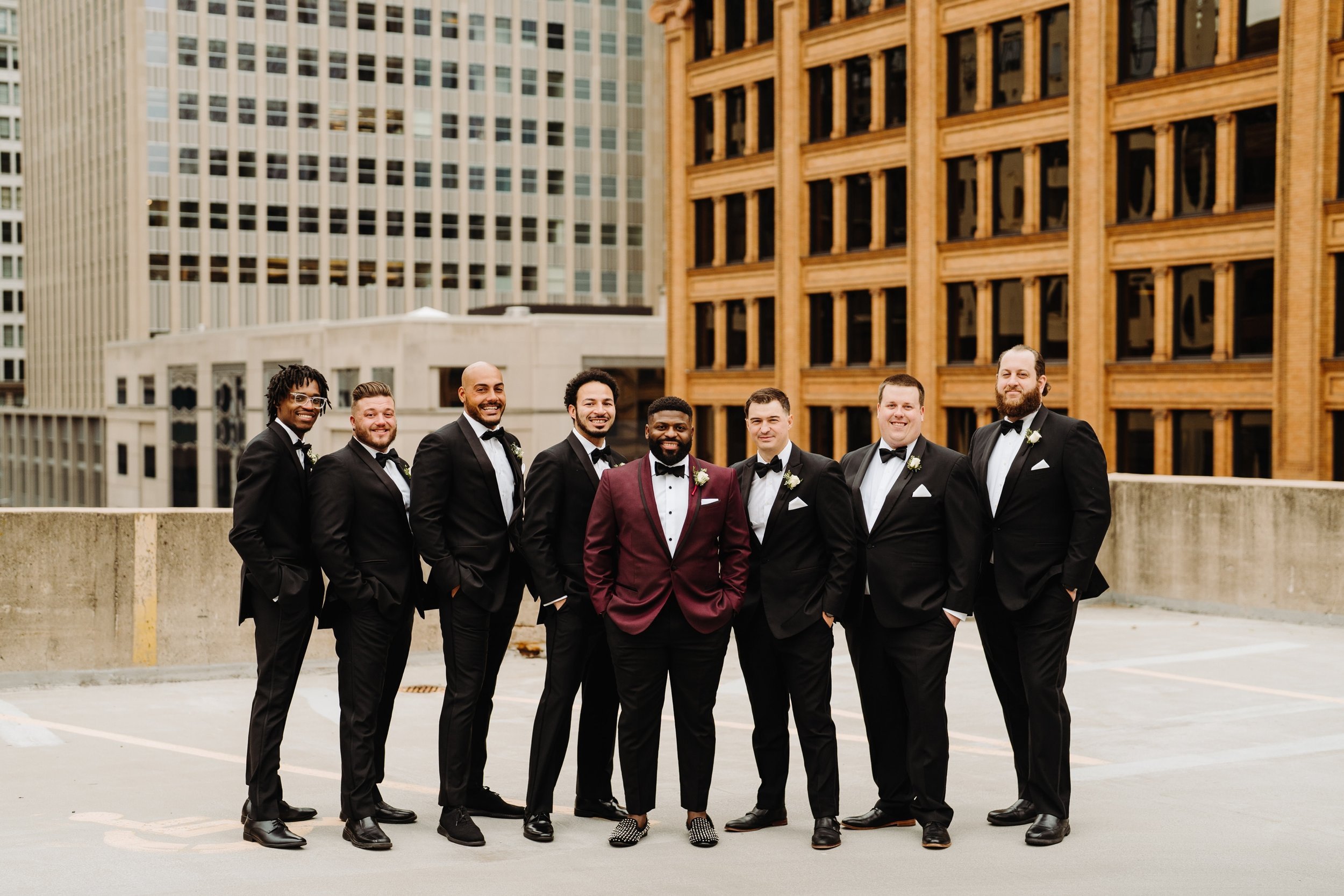 051_Groom and groomsmen in black and Burgundy tuxedos in downtown Minneapolis, Minnesota.%0A.jpg