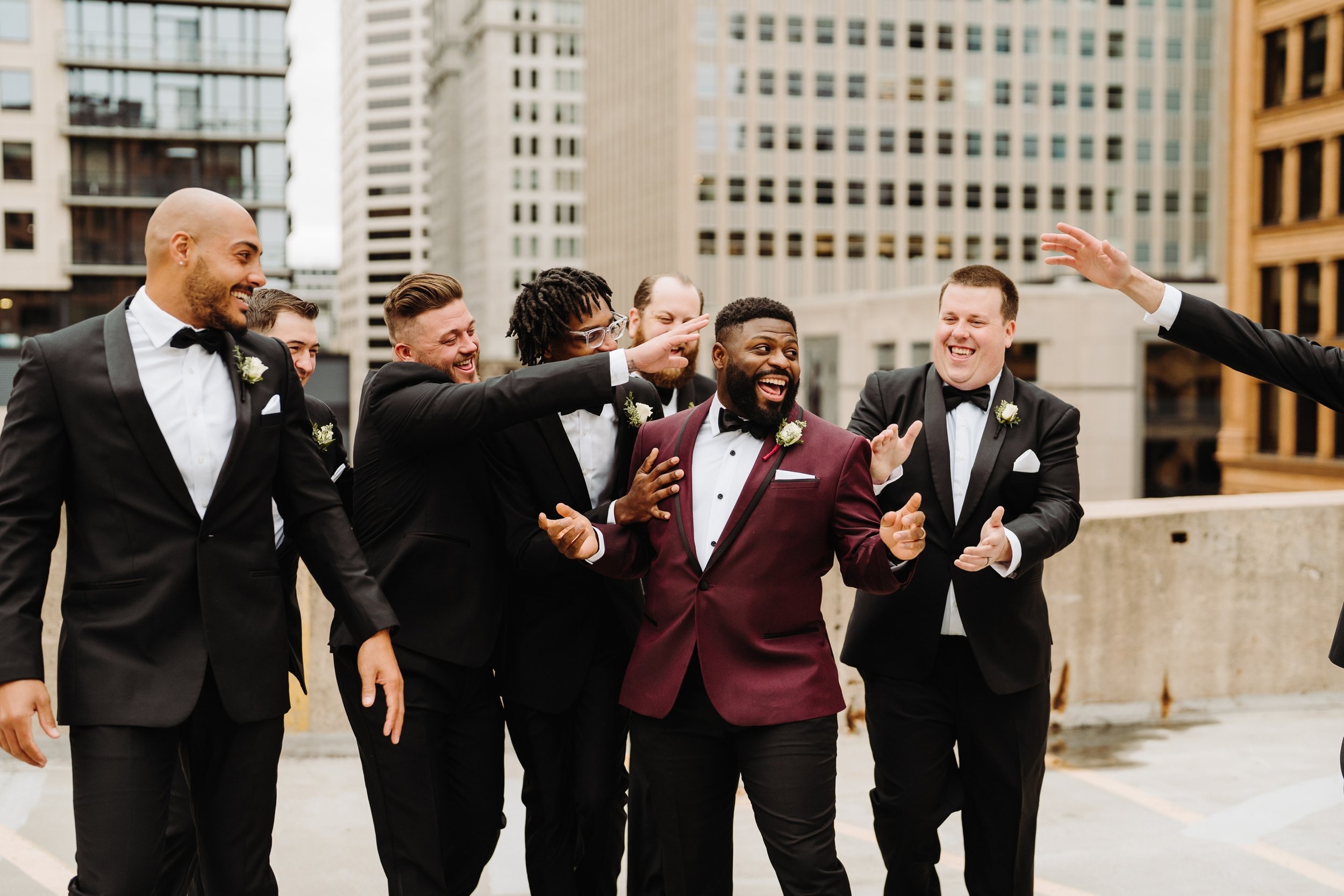052_Groom and groomsmen in black and Burgundy tuxedos in downtown Minneapolis, Minnesota..jpg