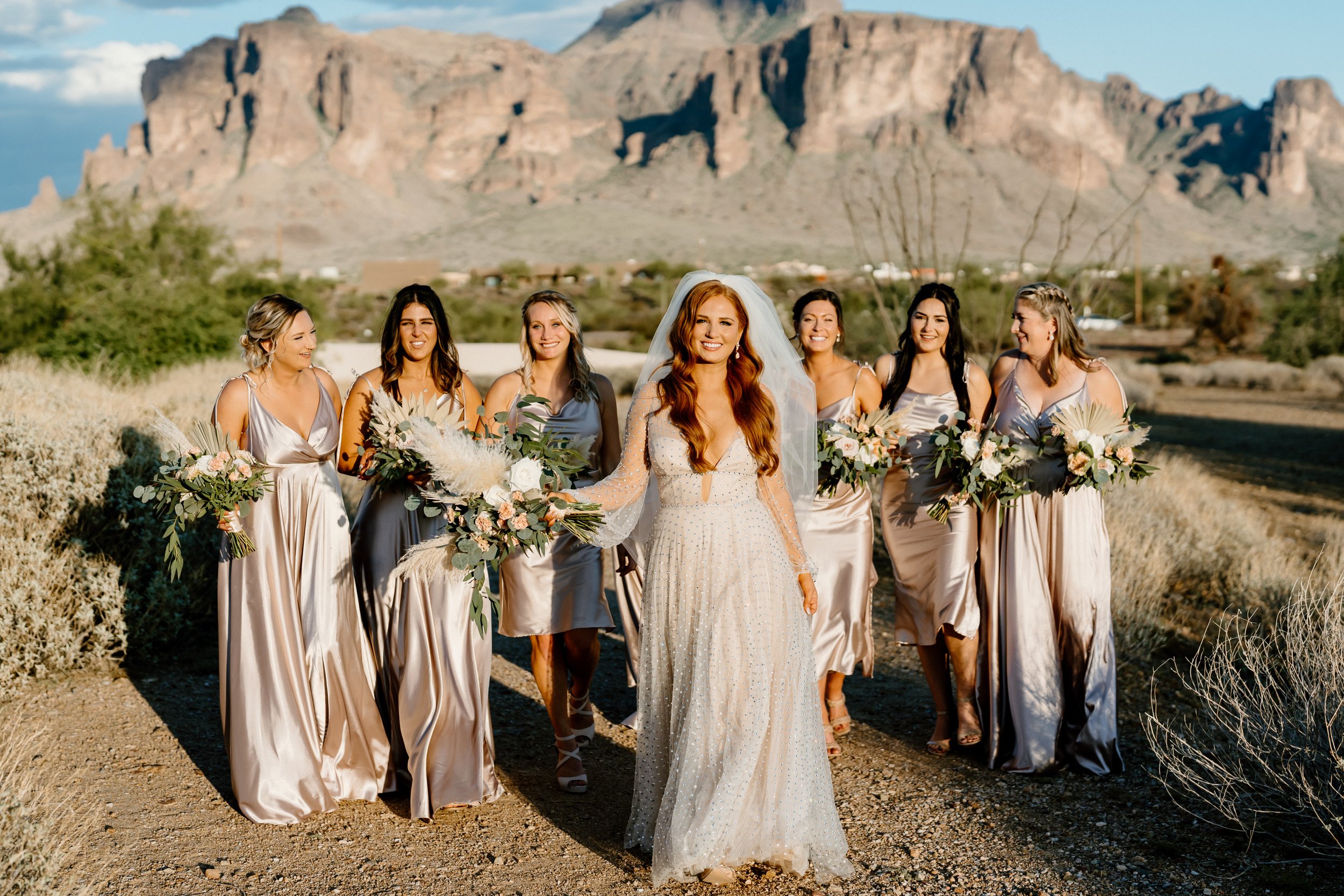 The Paseo Wedding with bridesmaids walking in front of the Superstition Mountains