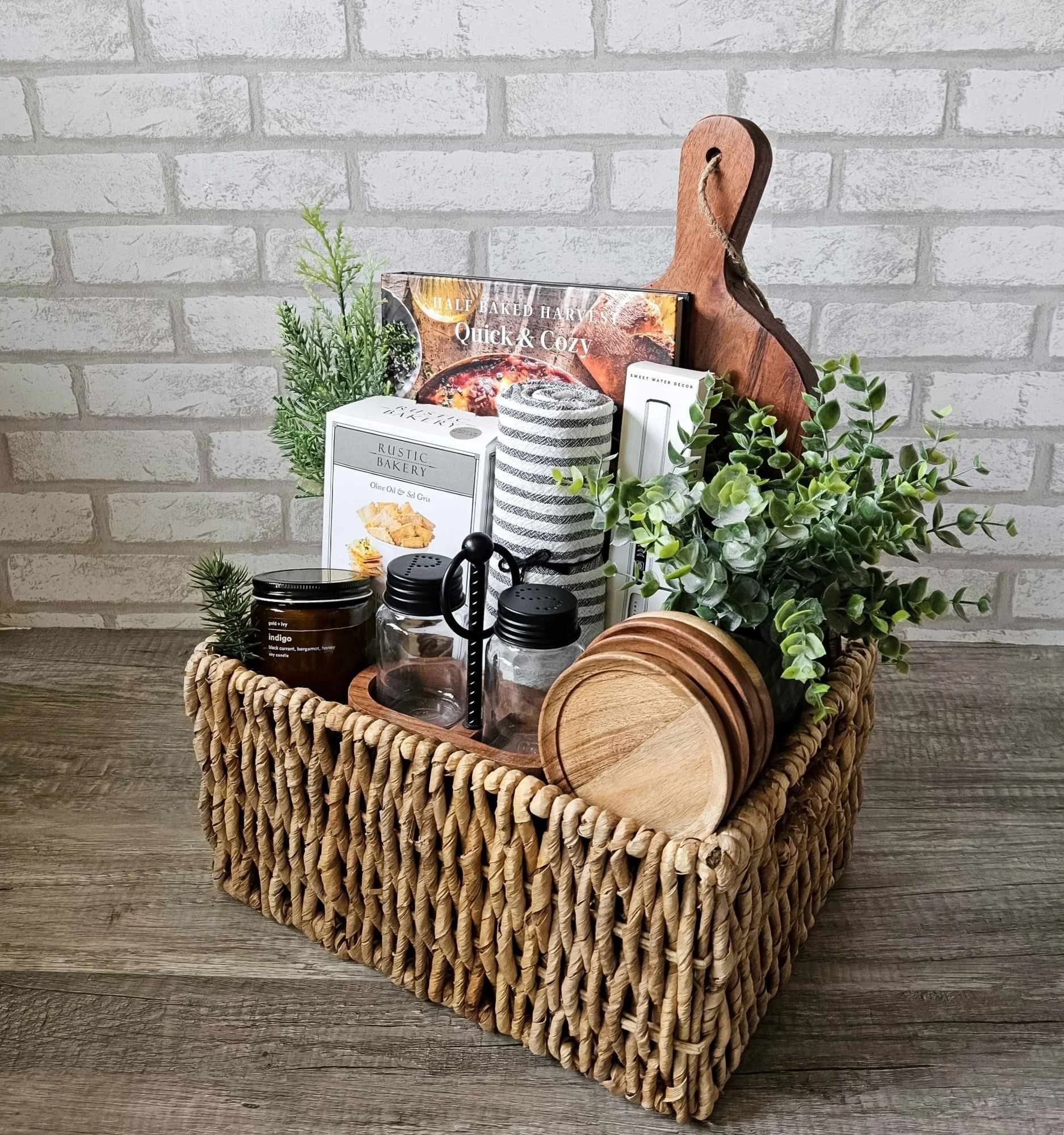 Rustic Harvest gift basket with cookbook, Indigo candle, tea towel, rechargeable lighter, wood accents, and gourmet flatbreads for housewarming gifting.