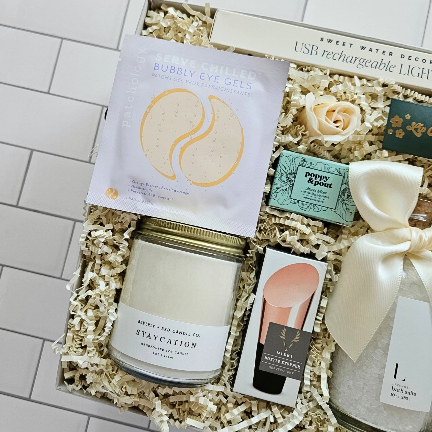 Spa-inspired gift set with candle, eye patches, and bath salts—an ideal anniversary or bridal gift for women who love to unwind