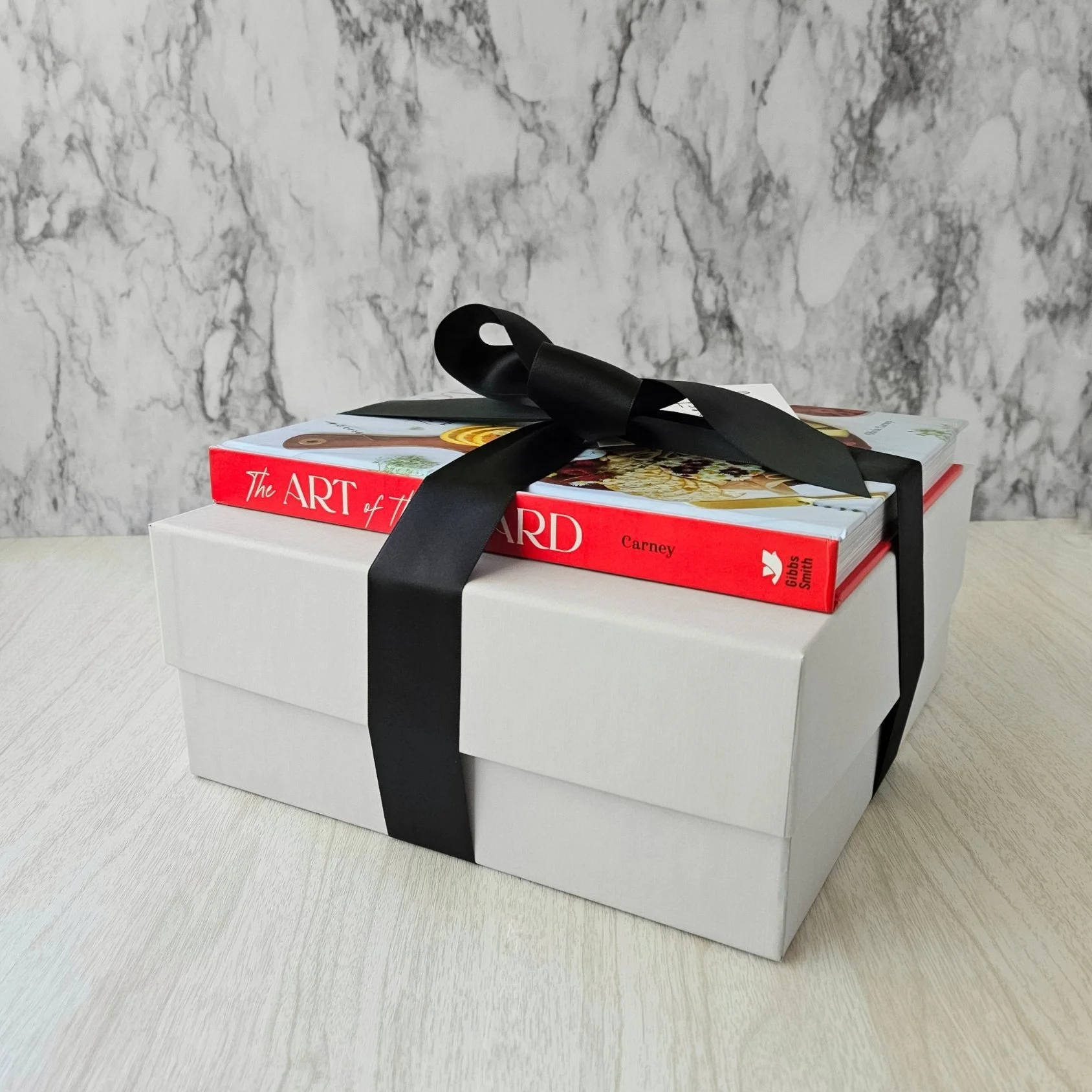 Luxury gift box with Art of the Board Hosting Cookbook and ribbon — perfect for entertainers, collectors, or holiday hosts