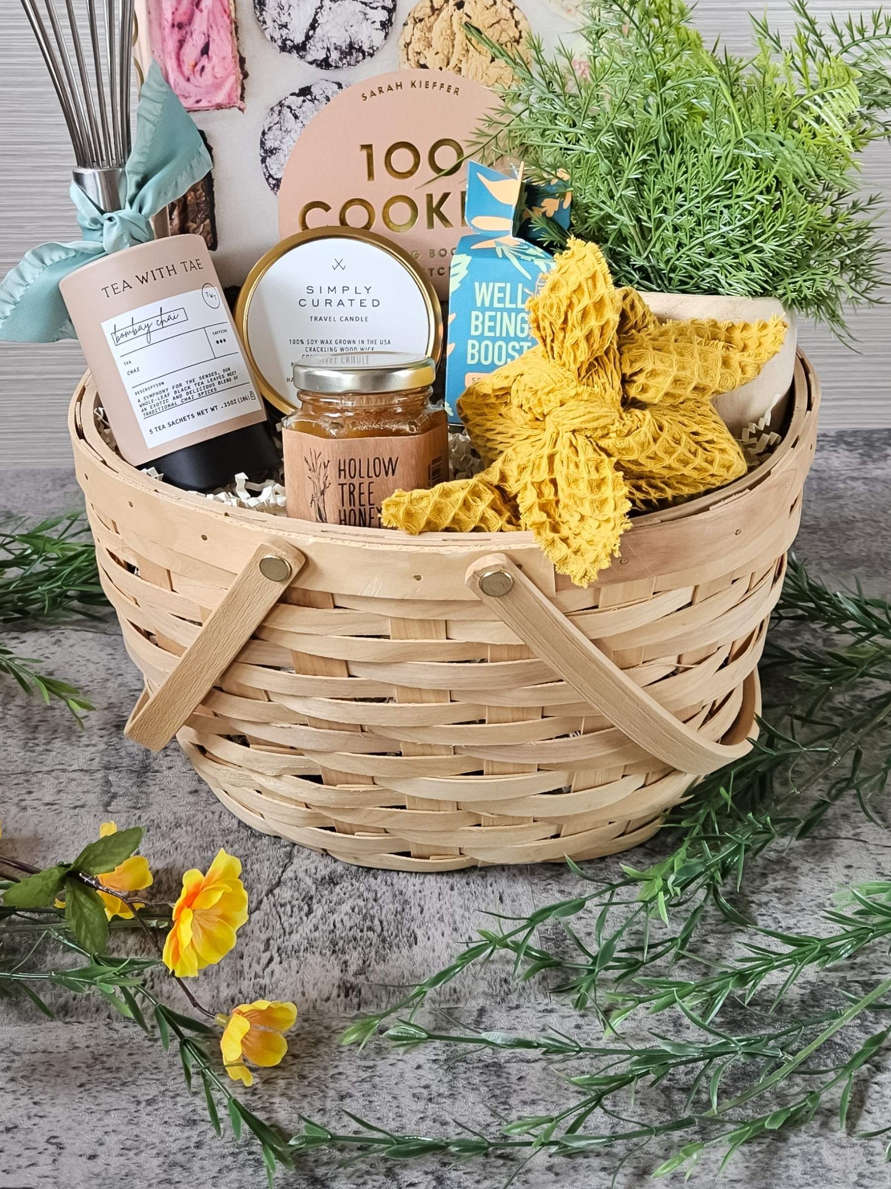 A beautifully curated gift basket featuring tea, baking essentials, and a plant—perfect for nature lovers, home chefs, and thoughtful gifting in any season.