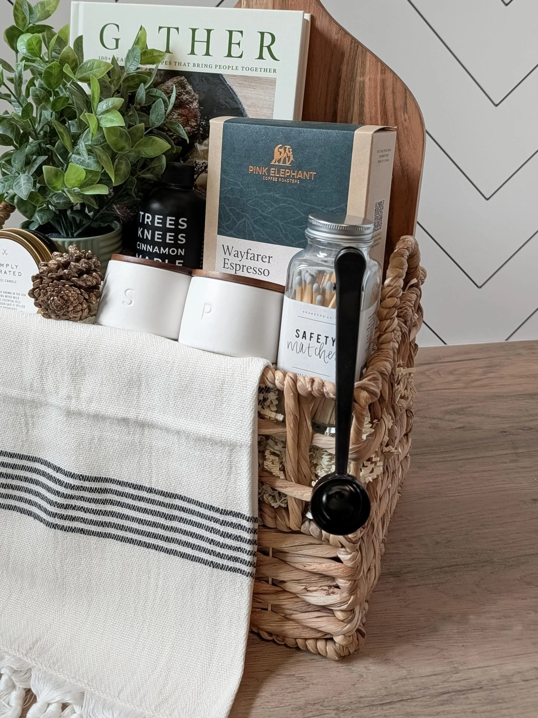 Luxury housewarming gift basket with gourmet coffee, maple syrup, a Turkish hand towel, and elegant home essentials.