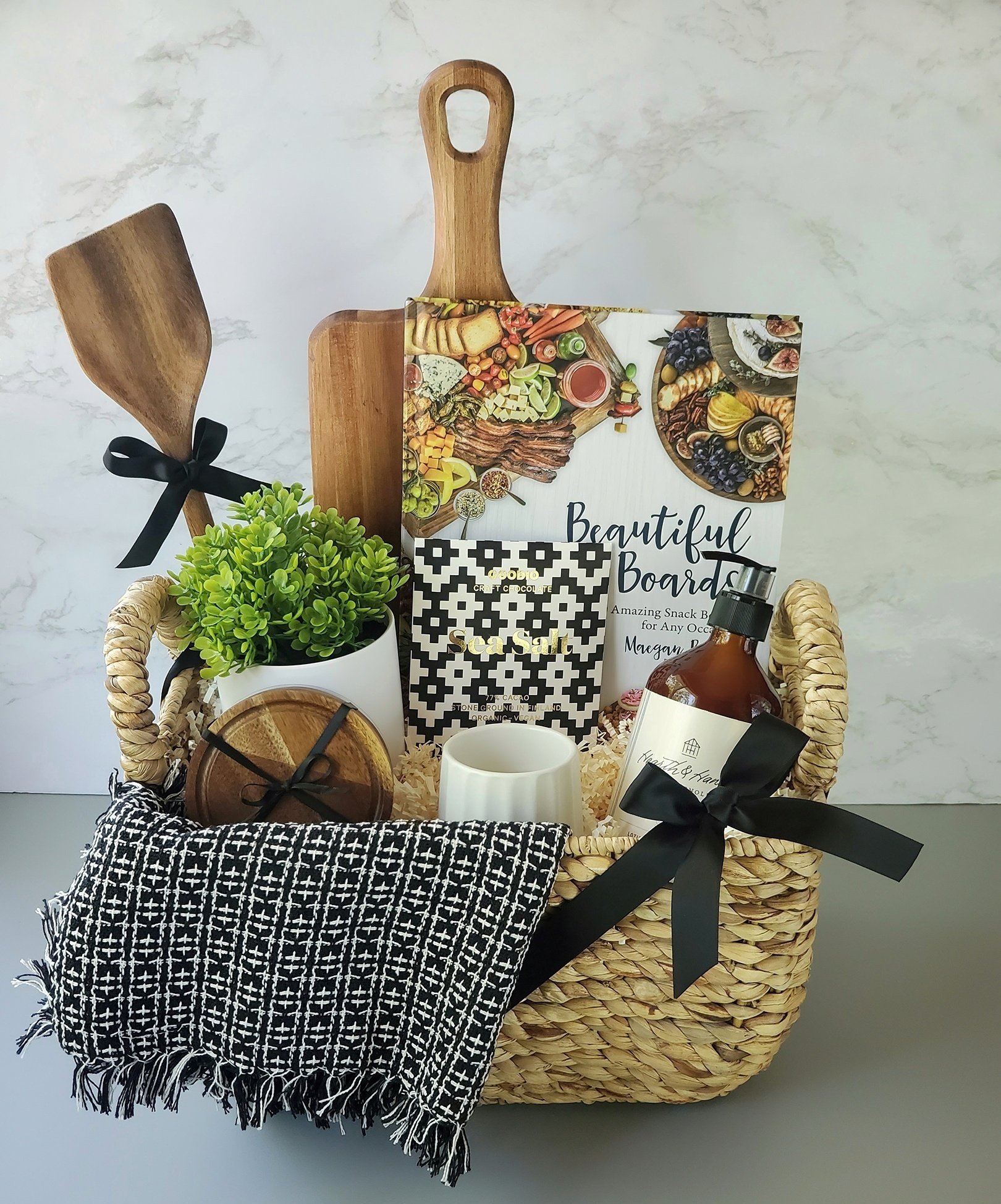 charcuterie board and book, coasters, hand soap, and lemon scented candle