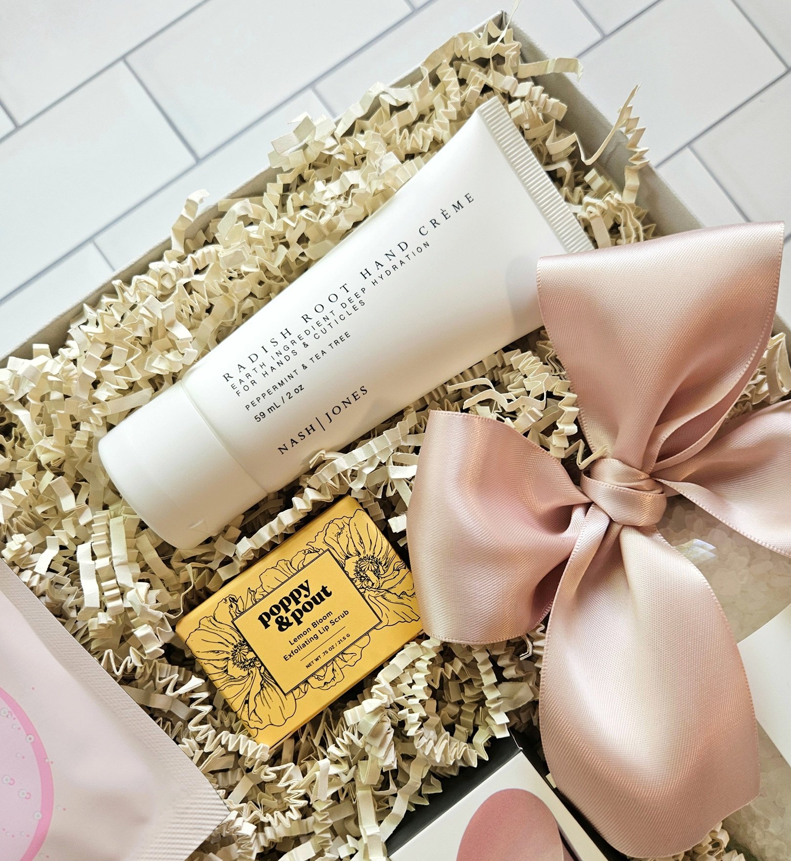 ultimate day spa gift complete with radish root hand cream, rose gold wine stopper, lavender bath salts, luxury candle, and lemon blossom lip scrub