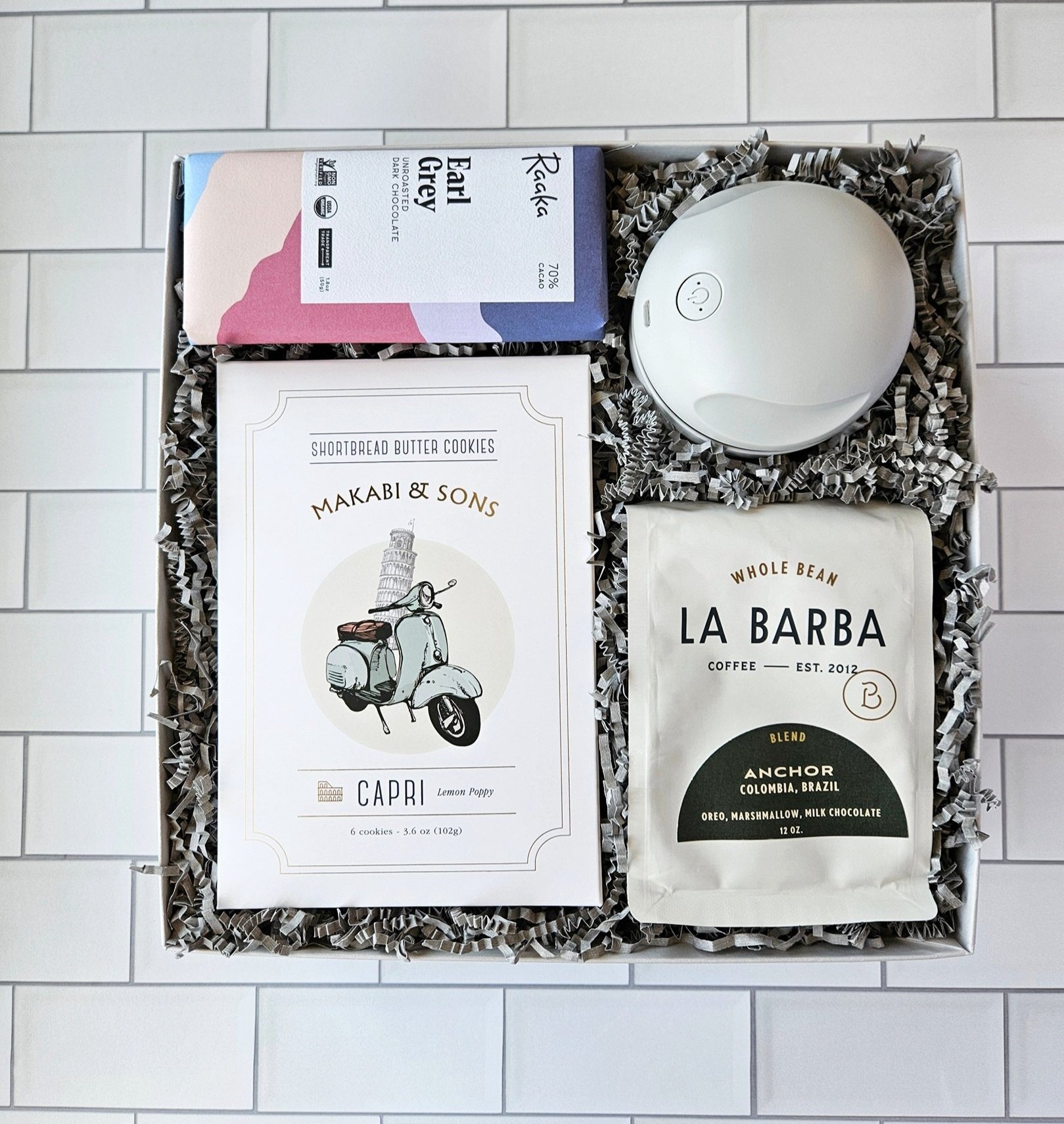 employee gift including gourmet coffee, earl grey chocolate bar, shortbread cookies, and a desk vacuum