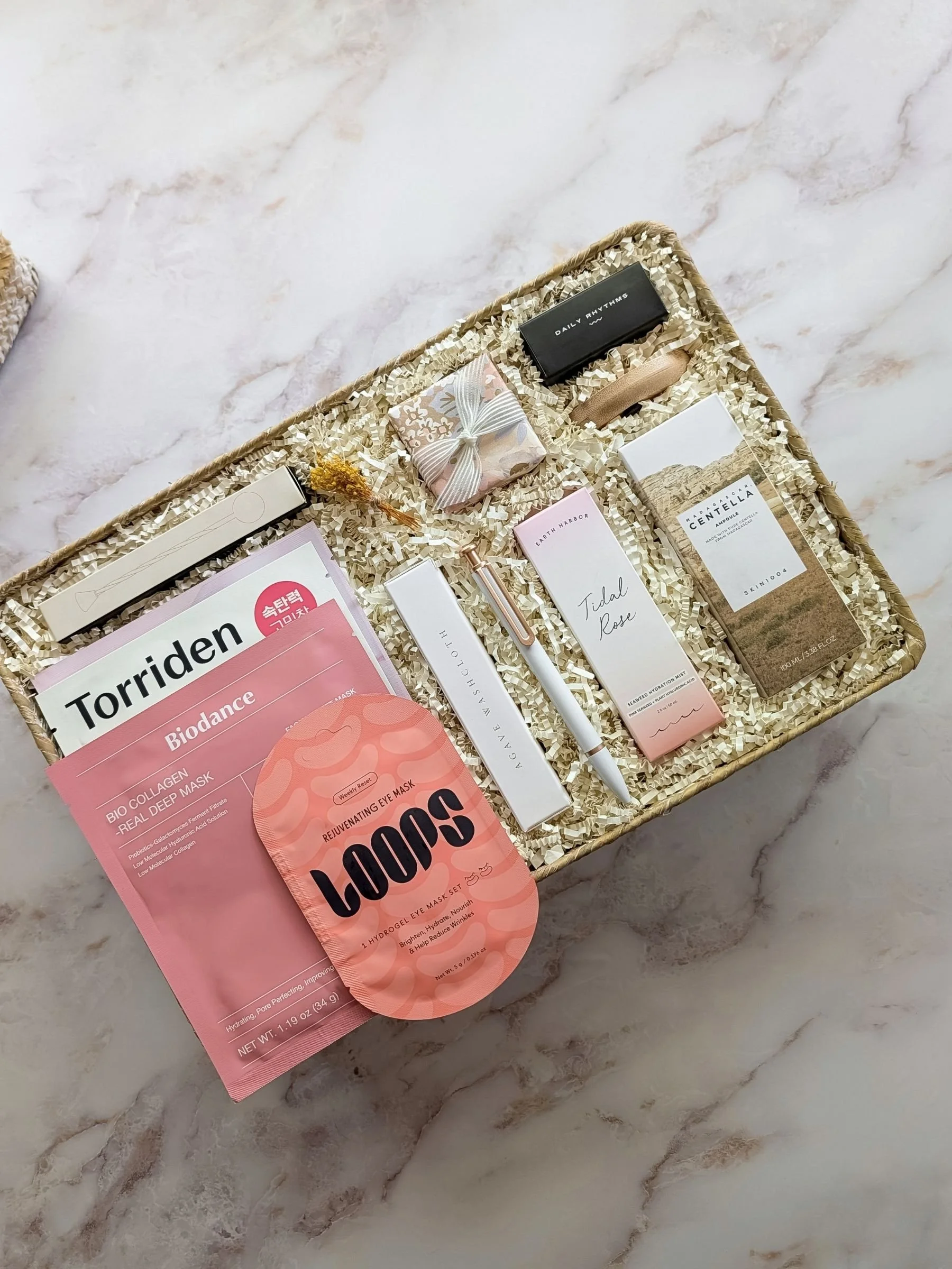 Luxury Mother’s Day spa gift basket filled with serum, face and eye masks, shower steamer, lip scrub and more.