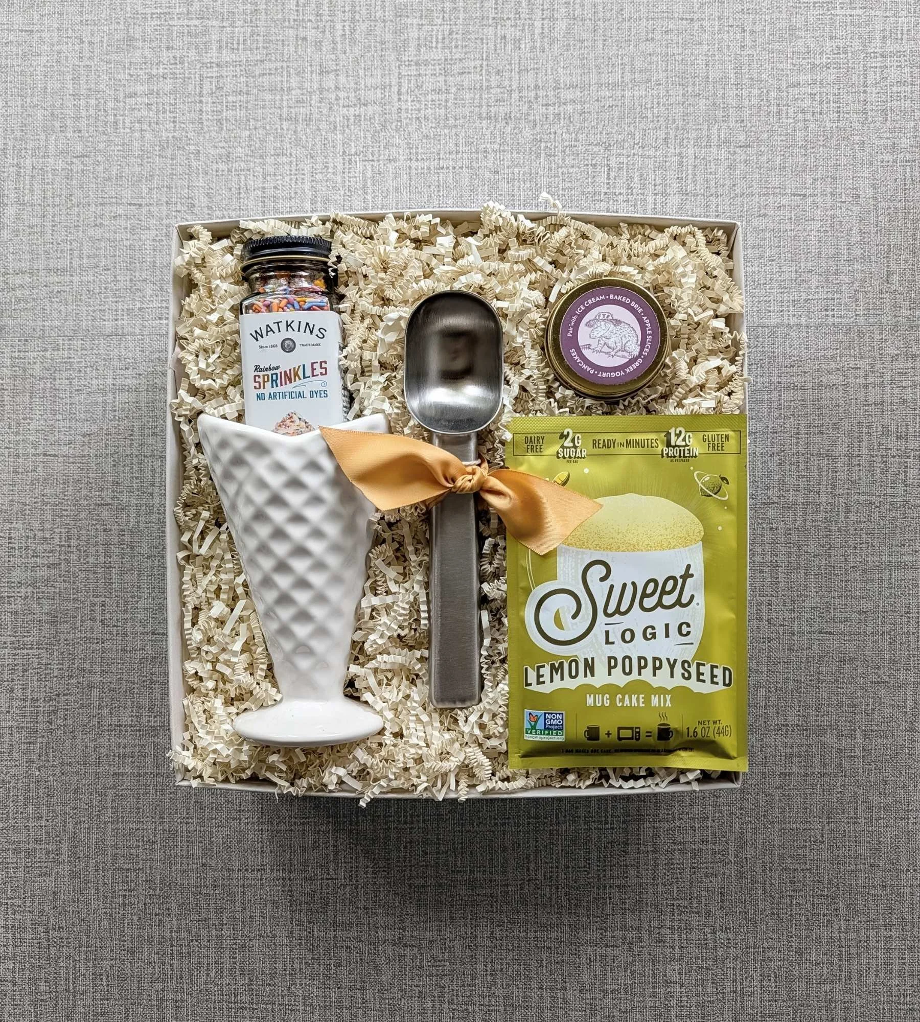 Nostalgic ice‑cream gift set with waffle‑cone bowl, mug cake mix, sprinkles, ice cream scoop, and vanilla bean caramel sauce.