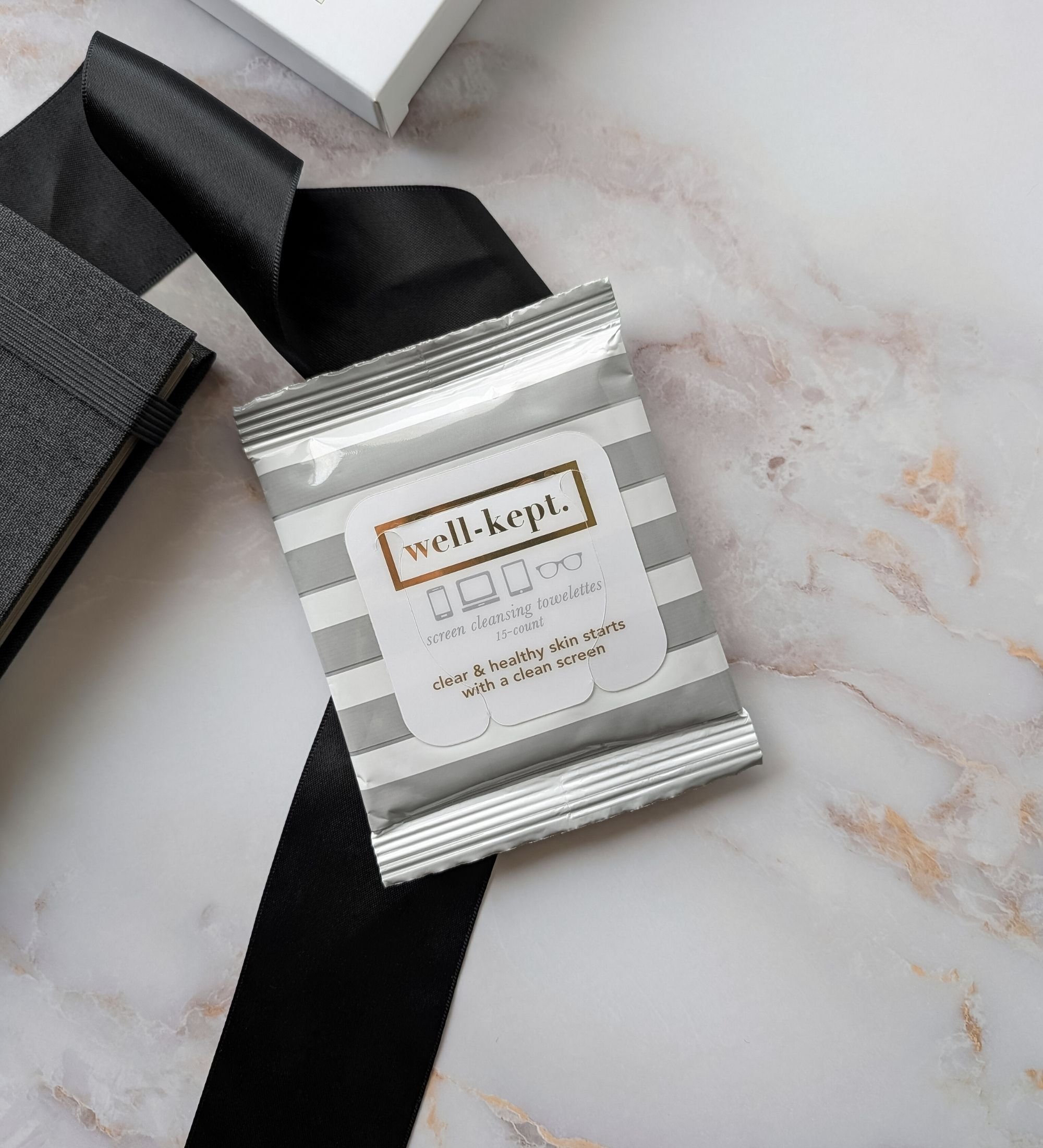 Close‑up of Well‑Kept screen wipes from The Ledger gift bundle, clean modern packaging with soft neutral tones
