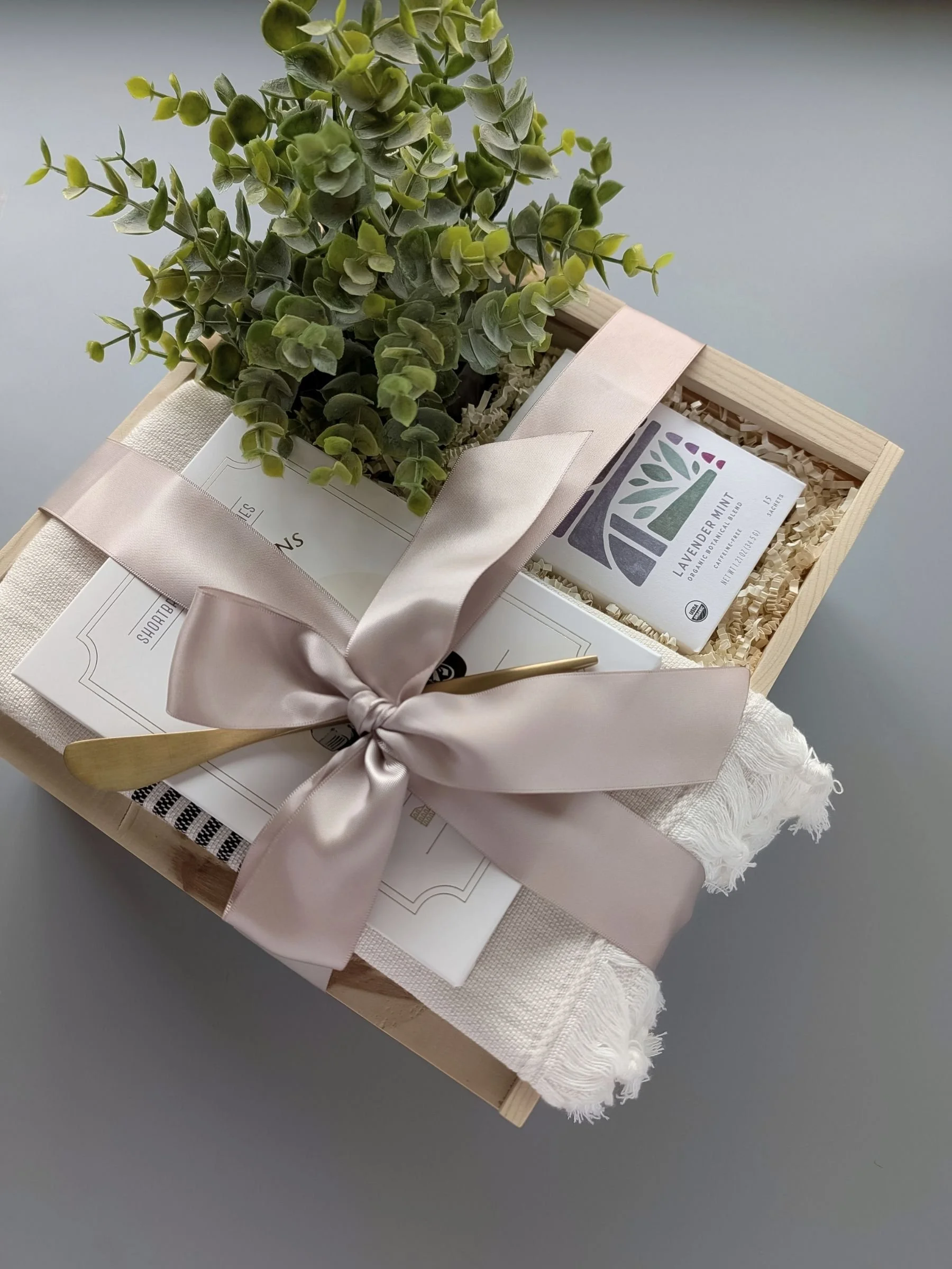 Wooden slide‑top Tea Time gift box with calming tea, Turkish towel, lemon poppy shortbread cookies, and an elegant gold spreader.