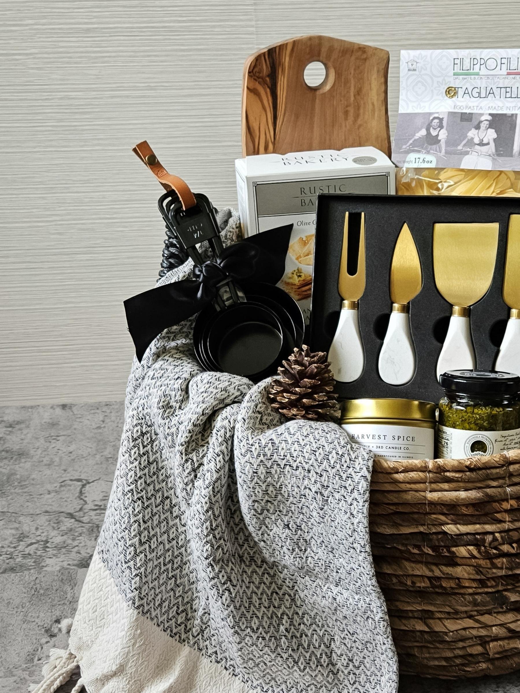 Italian‑inspired Pasta Night gift basket with pasta, pesto, capers, Truff hot sauce, and a marble cheese knife set for gourmet home cooking.