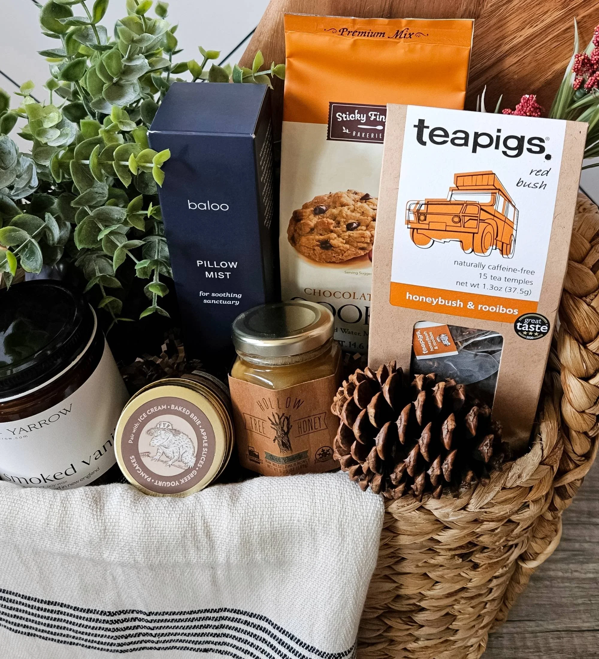Modern rustic gift basket with cozy home essentials, grounding scents, gourmet treats, and artisan textures—perfect for housewarmings or weddings.
