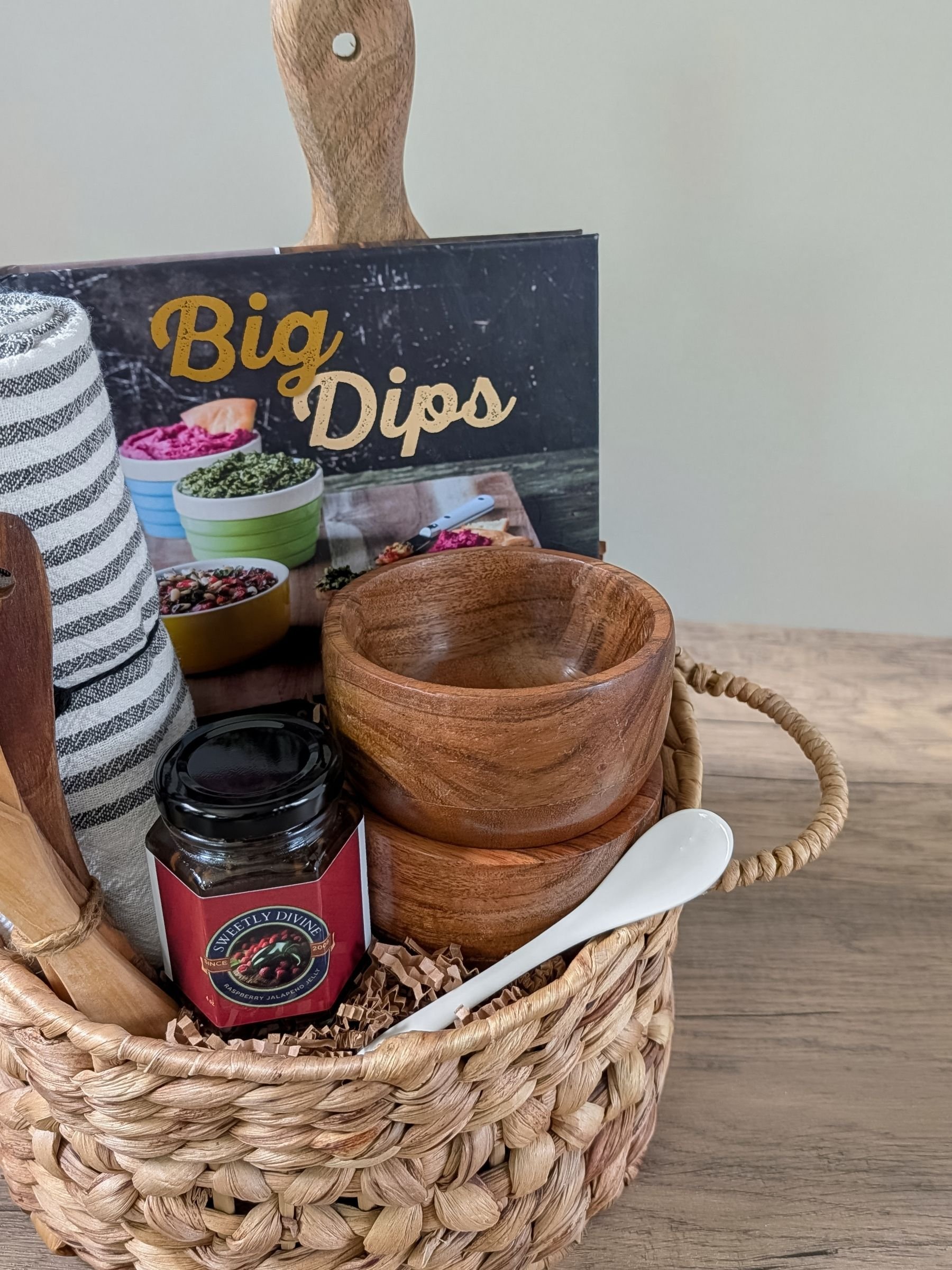 Gourmet Bistro gift basket with acacia dip bowls, a ceramic spoon, Dips book, and wood serving board.