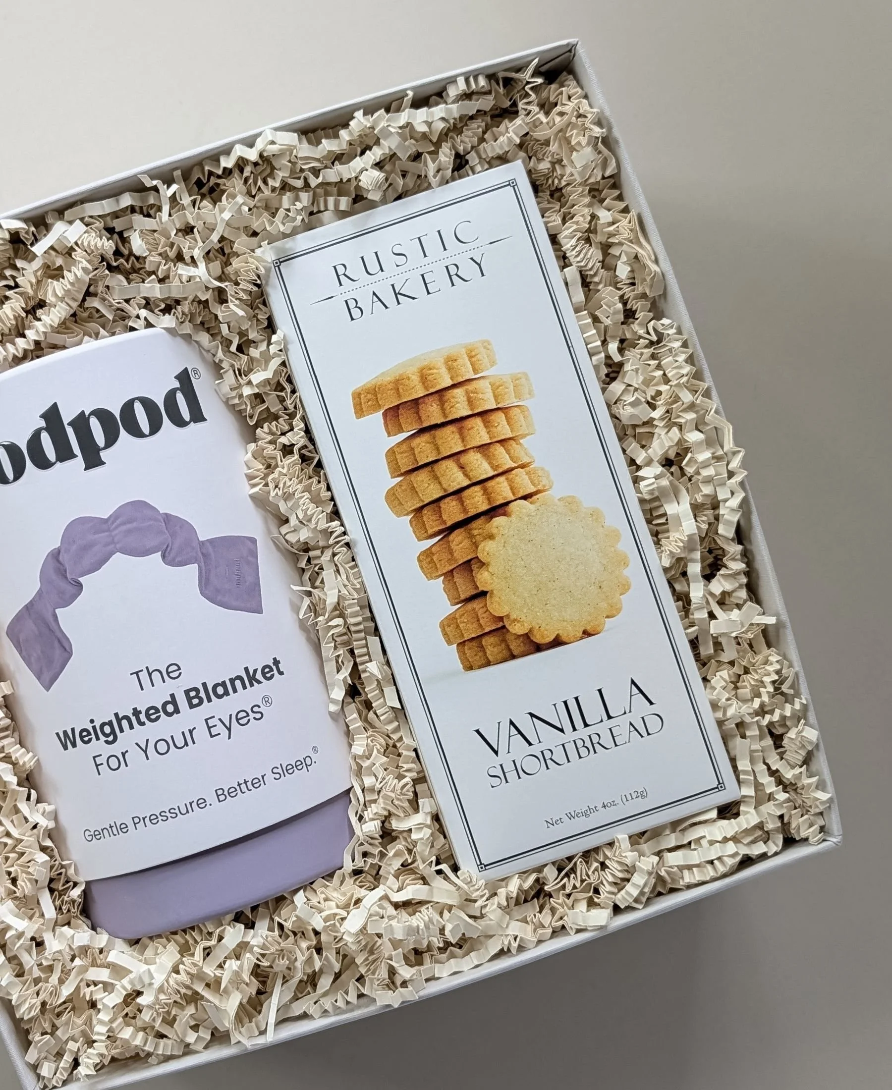 The linen retreat featuring gourmet vanilla shortbread cookies and a lavender weighted eye mask by Nodpod, nestled in a linen gift box and ivory crinkle paper