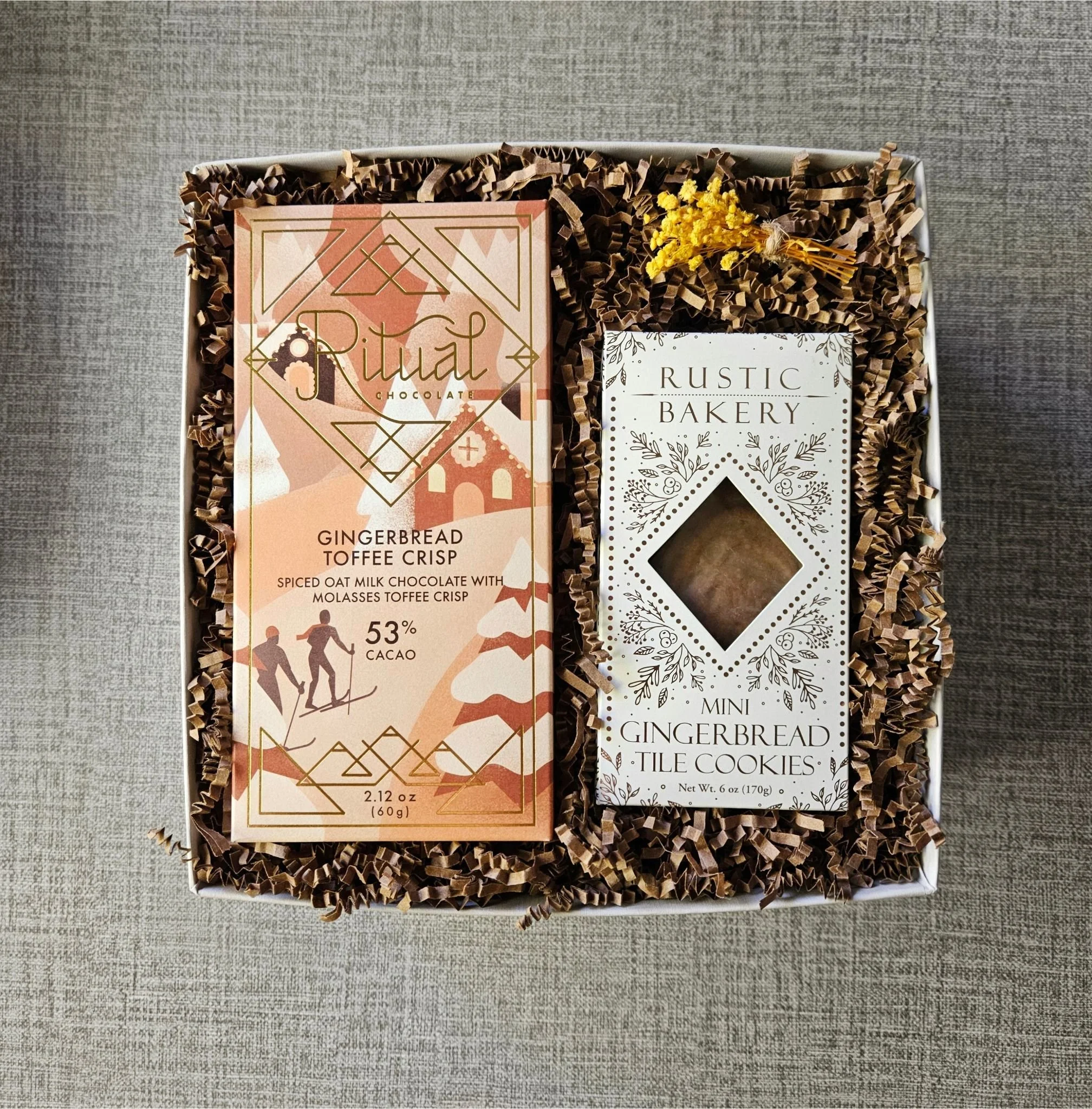 Delight loved ones this holiday season with The Gingerbread Gift Box, featuring a toffee chocolate bar and mini gingerbread tile cookies.