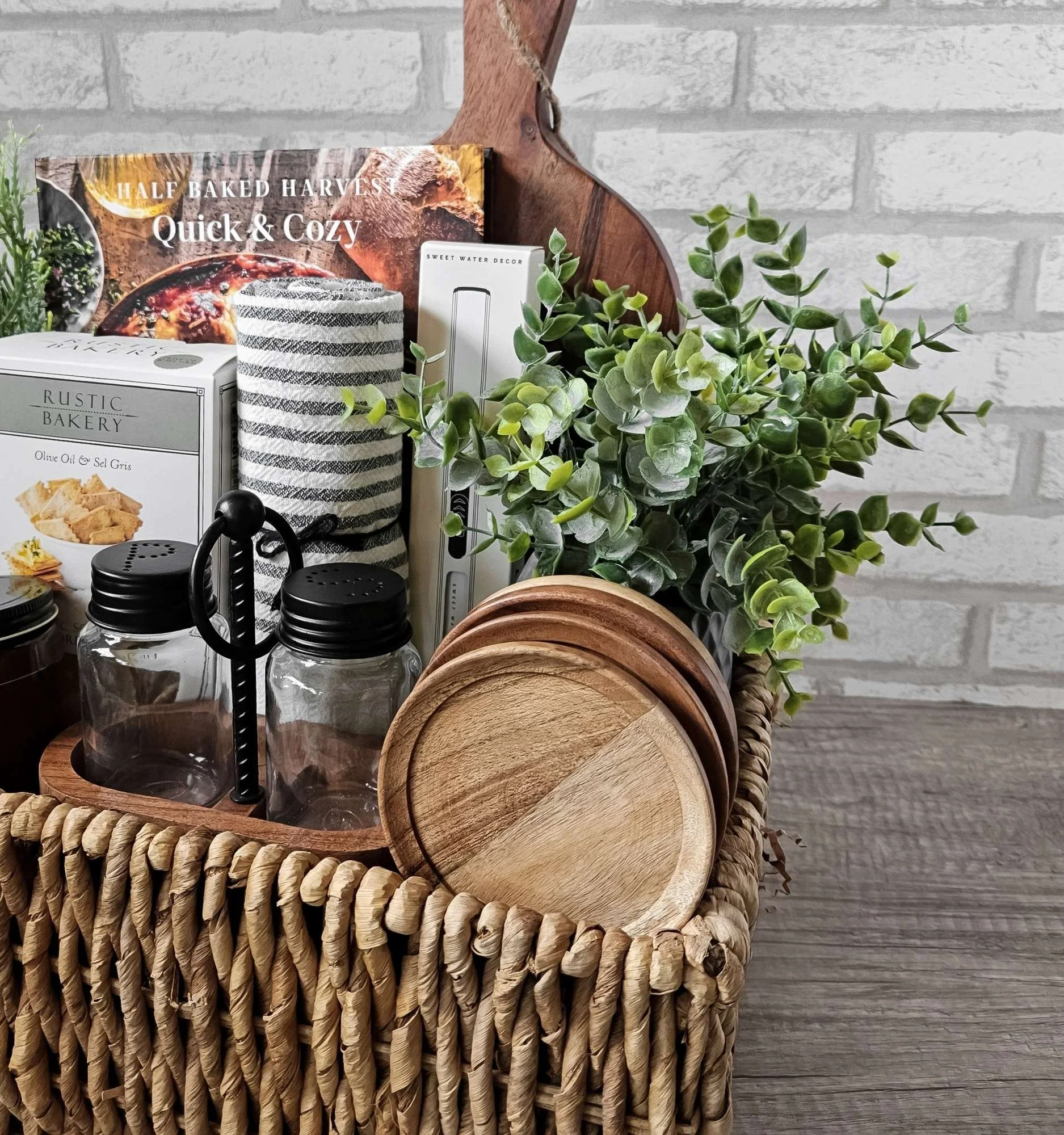 Rustic Harvest home gift basket with modern kitchen essentials, candle, towel, lighter, wood accents, and gourmet treats for new homeowners.