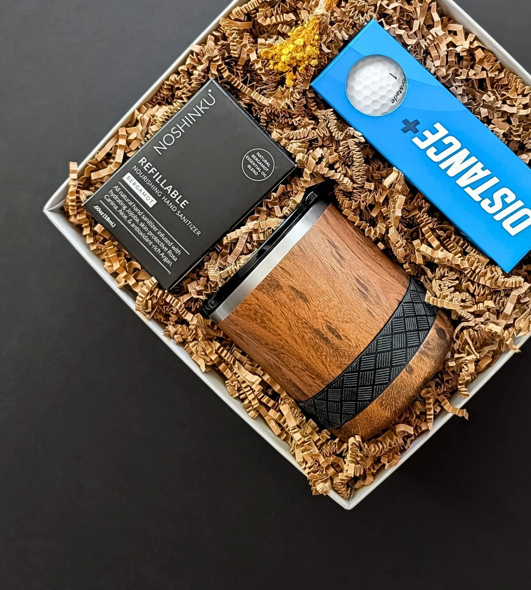 Men’s golf gift set featuring Distance+ golf balls, refillable Noshinku sanitizer, and a teakwood tumbler in a premium gift box.