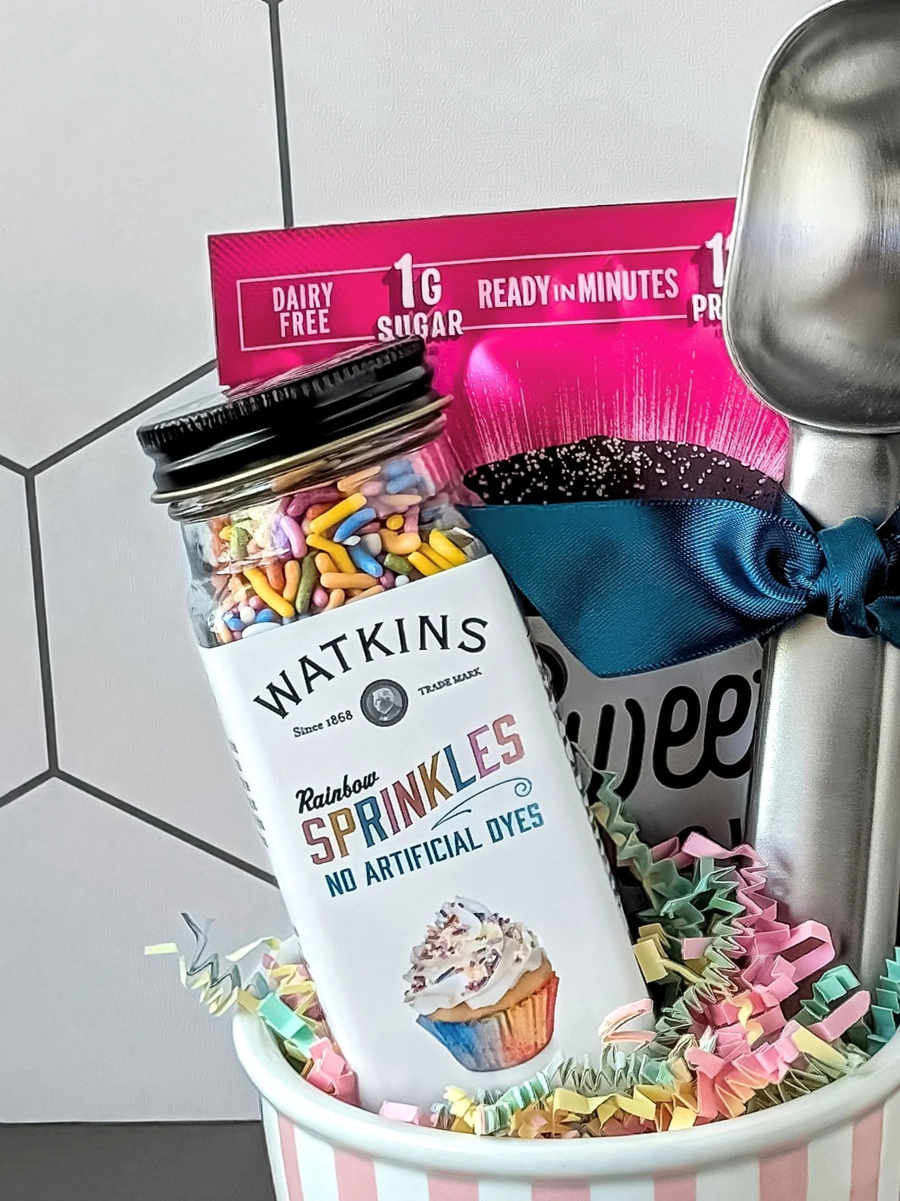 Close‑up of ceramic ice cream bowl and rainbow sprinkles included in The Parlor gift bundle.