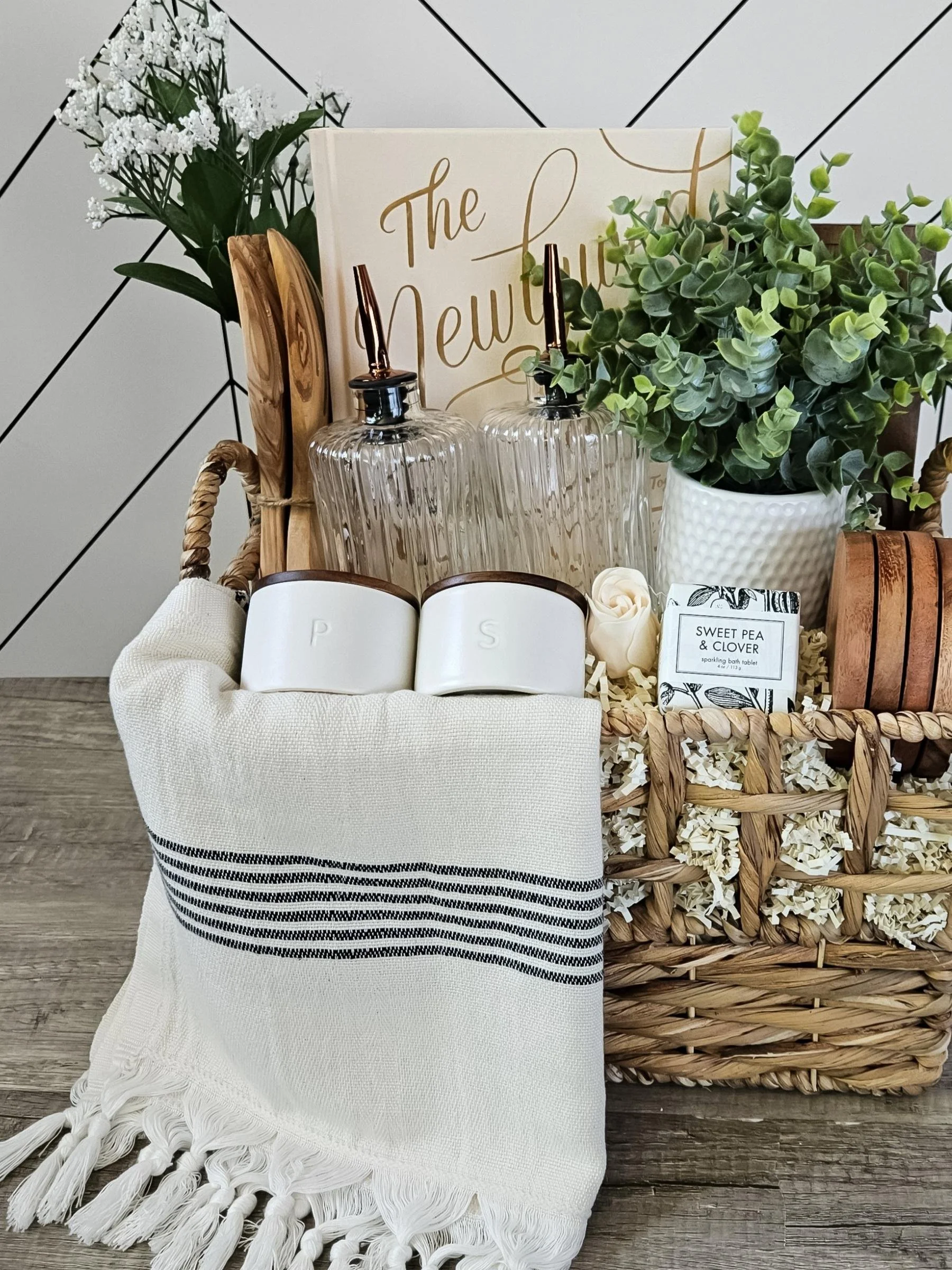 Luxury newlywed gift basket with newlywed cookbook, stone salt and pepper cellars, glass oil dispensers, and modern home accents
