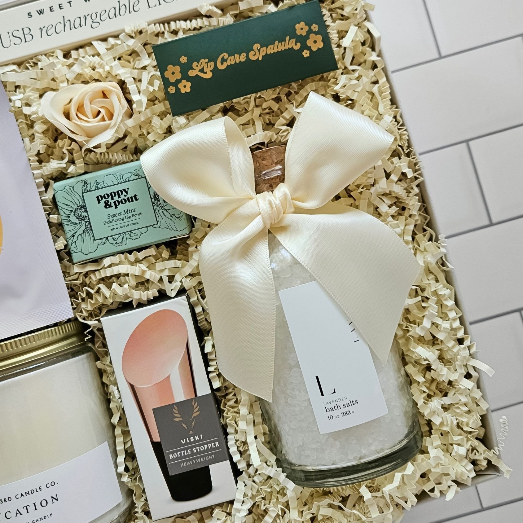 Self-care gift box for her with lavender bath salts, wine stopper, eye gels, and lip scrub—perfect for birthdays or bridal showers