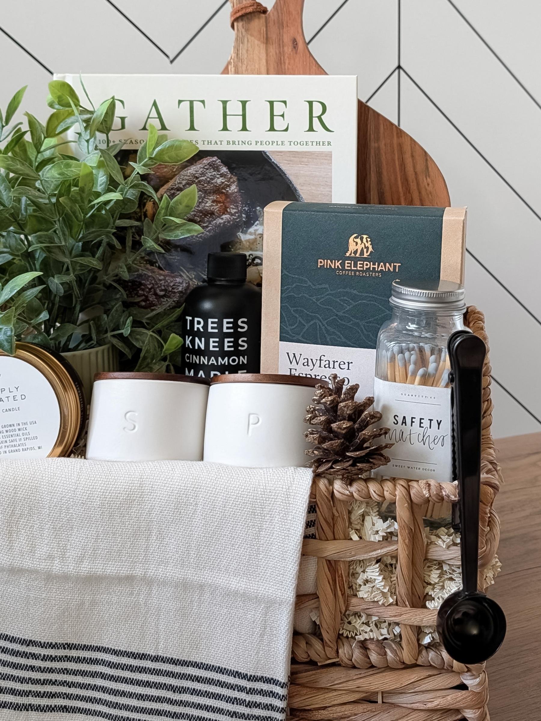 Elegant closing gift basket with a Gather cookbook, cinnamon maple syrup, salt & pepper cellars, and artisanal accents for a sophisticated touch.