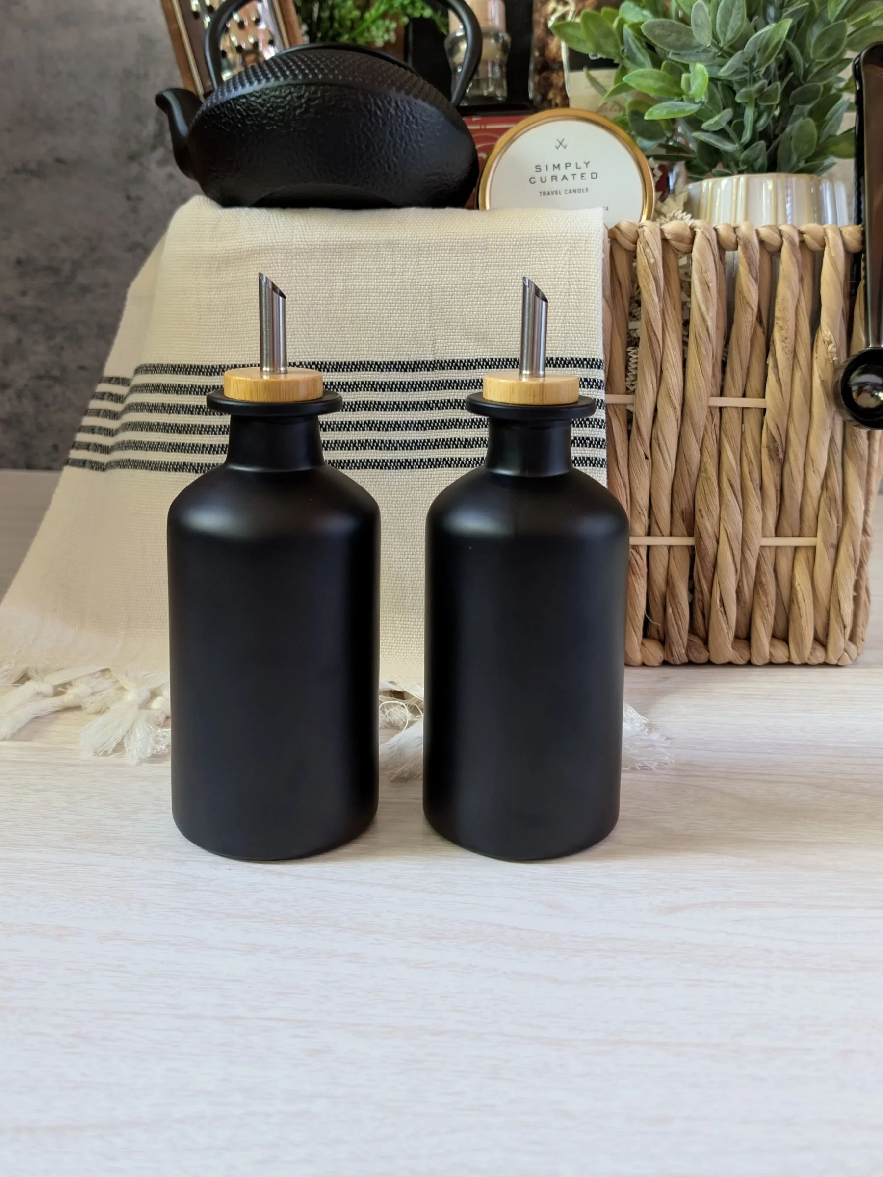 Modern housewarming gift basket with sleek matte black oil dispensers with glass measuring cup lids.