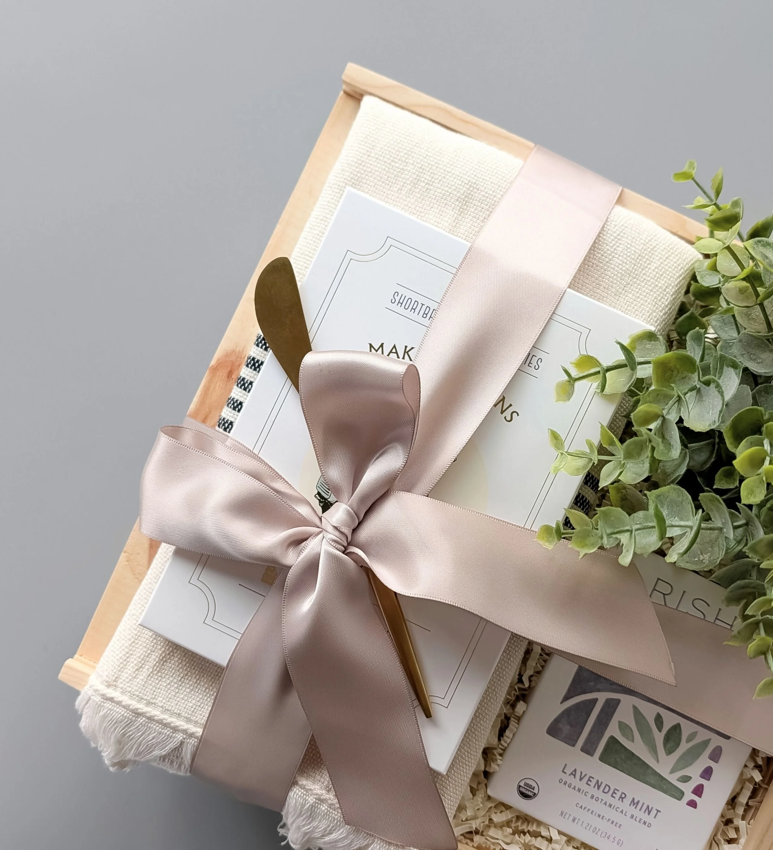 Curated Tea gift box with Rishi Lavender Mint Tea, a striped Turkish towel, lemon poppy shortbread, and a gold spreader.