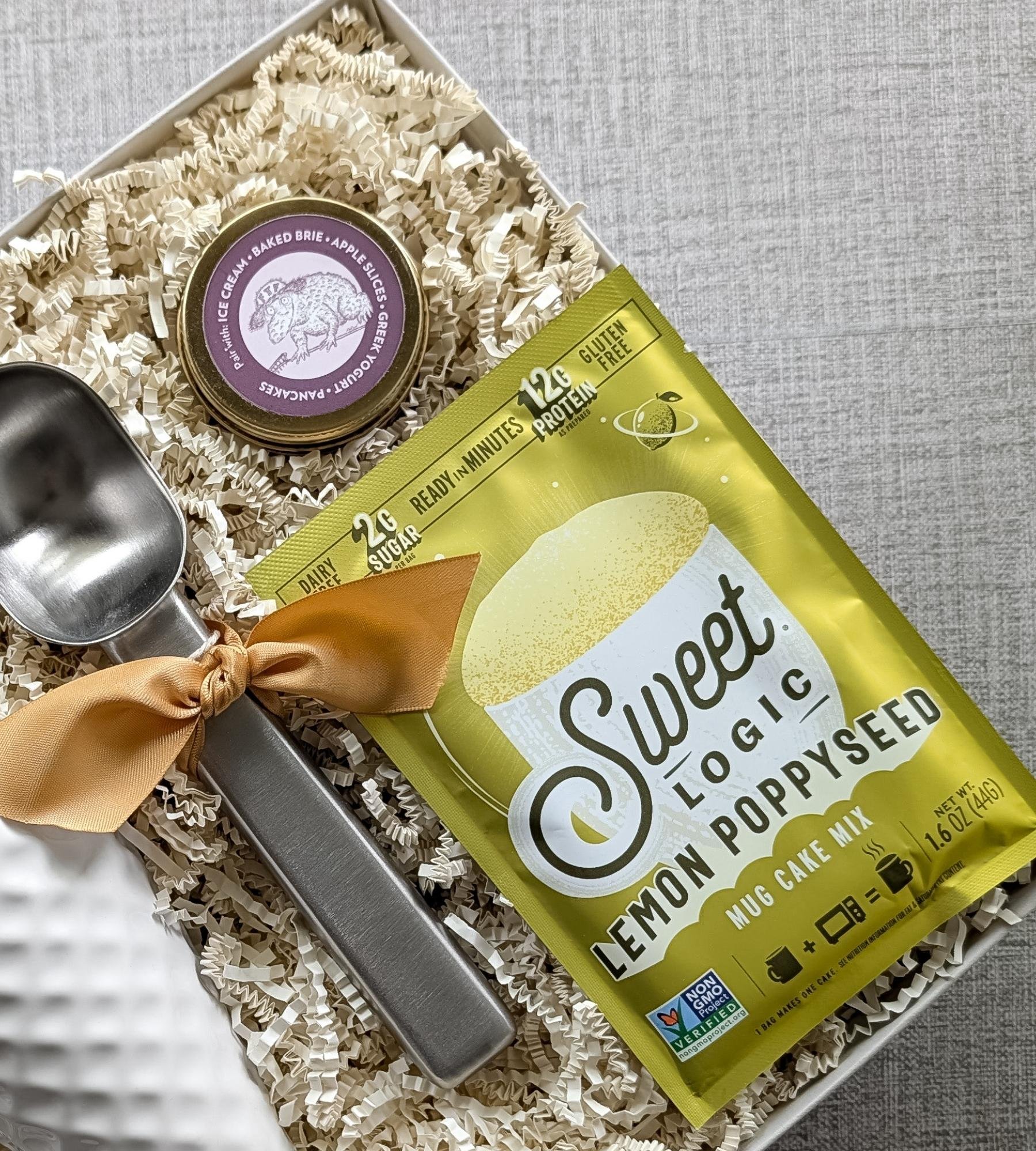 Fun summer gift box for ice‑cream lovers with a lemon poppyseed keto mug cake mix, small batch vanilla bean caramel sauce, and stainless-steel scoop.