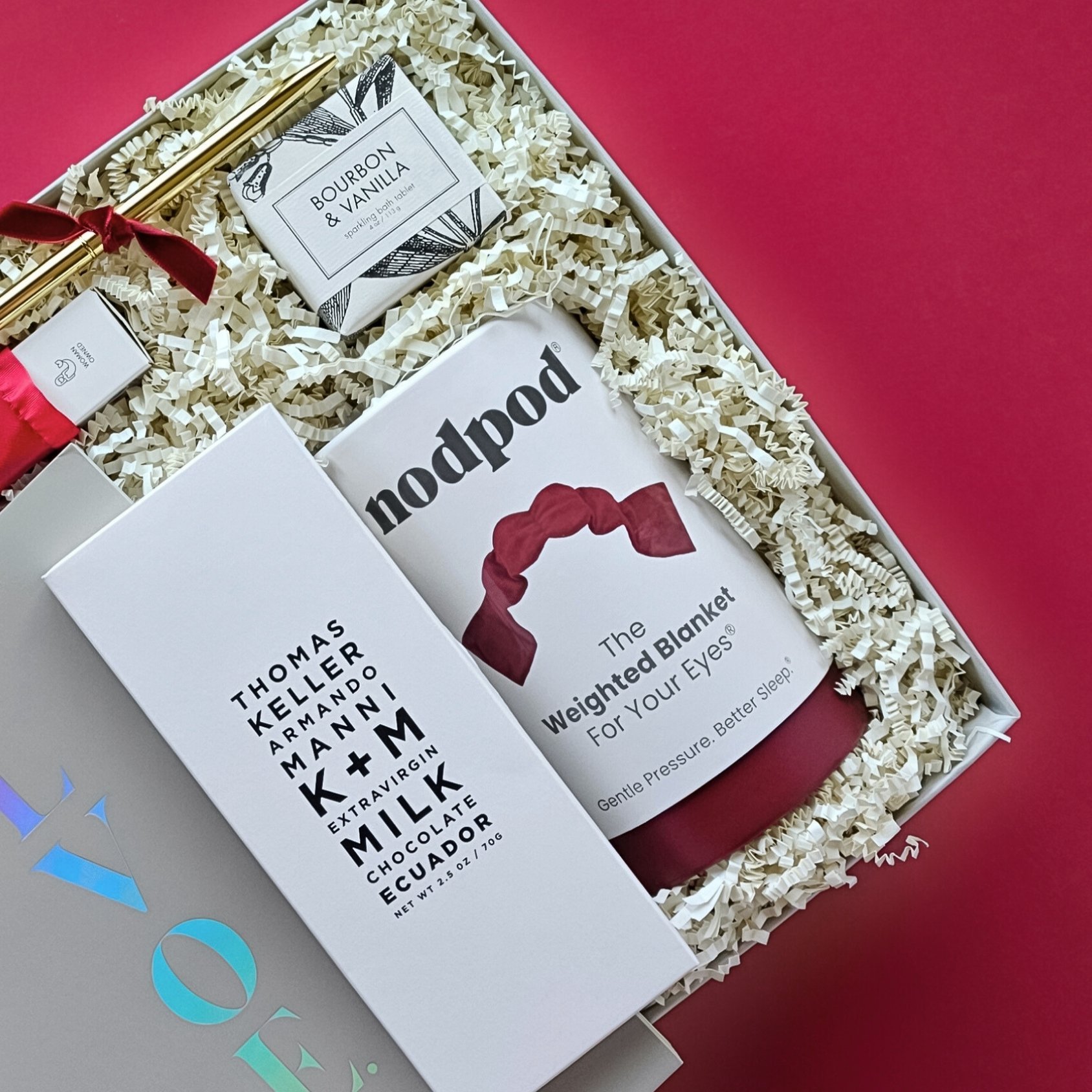 Romantic Valentine’s gift box featuring a red weighted eye mask, bourbon vanilla bath tablet, K+M chocolate bar, and Atticus poetry book.