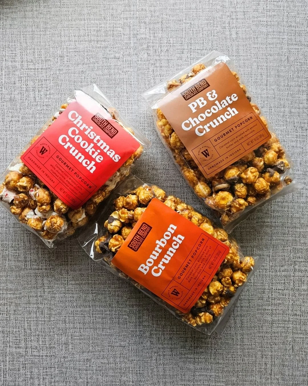 - South Bend flavors: Image featuring three holiday popcorn flavors: Christmas Cookie Crunch, Peanut Butter Crunch, and Bourbon Crunch.