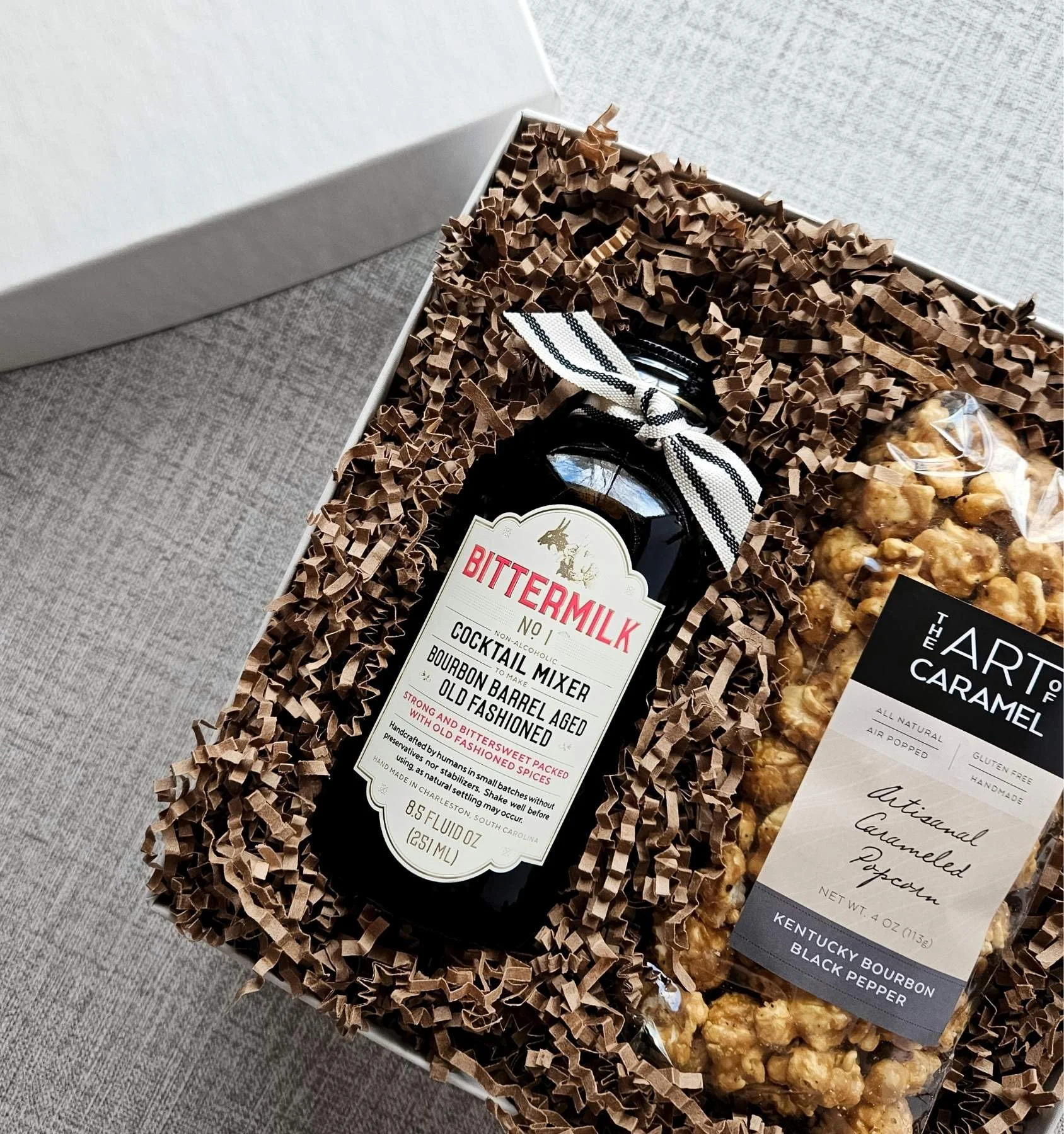 Mini bourbon gift set featuring an 8.5 oz Old Fashioned cocktail mixer and gourmet bourbon black pepper popcorn for men or corporate gifting.