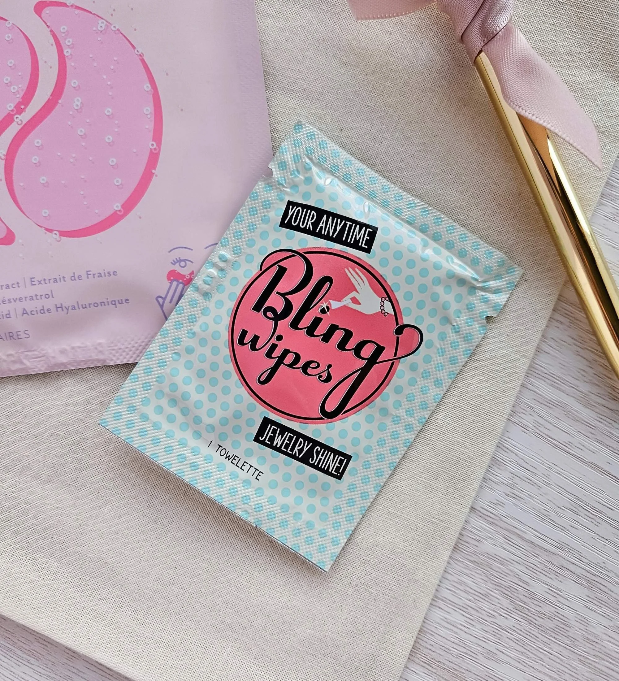 Bling Ring Wipes, Rosé eye gels and gold pen styled on a flat cotton bridal bag for the Mini “I Do” gift.