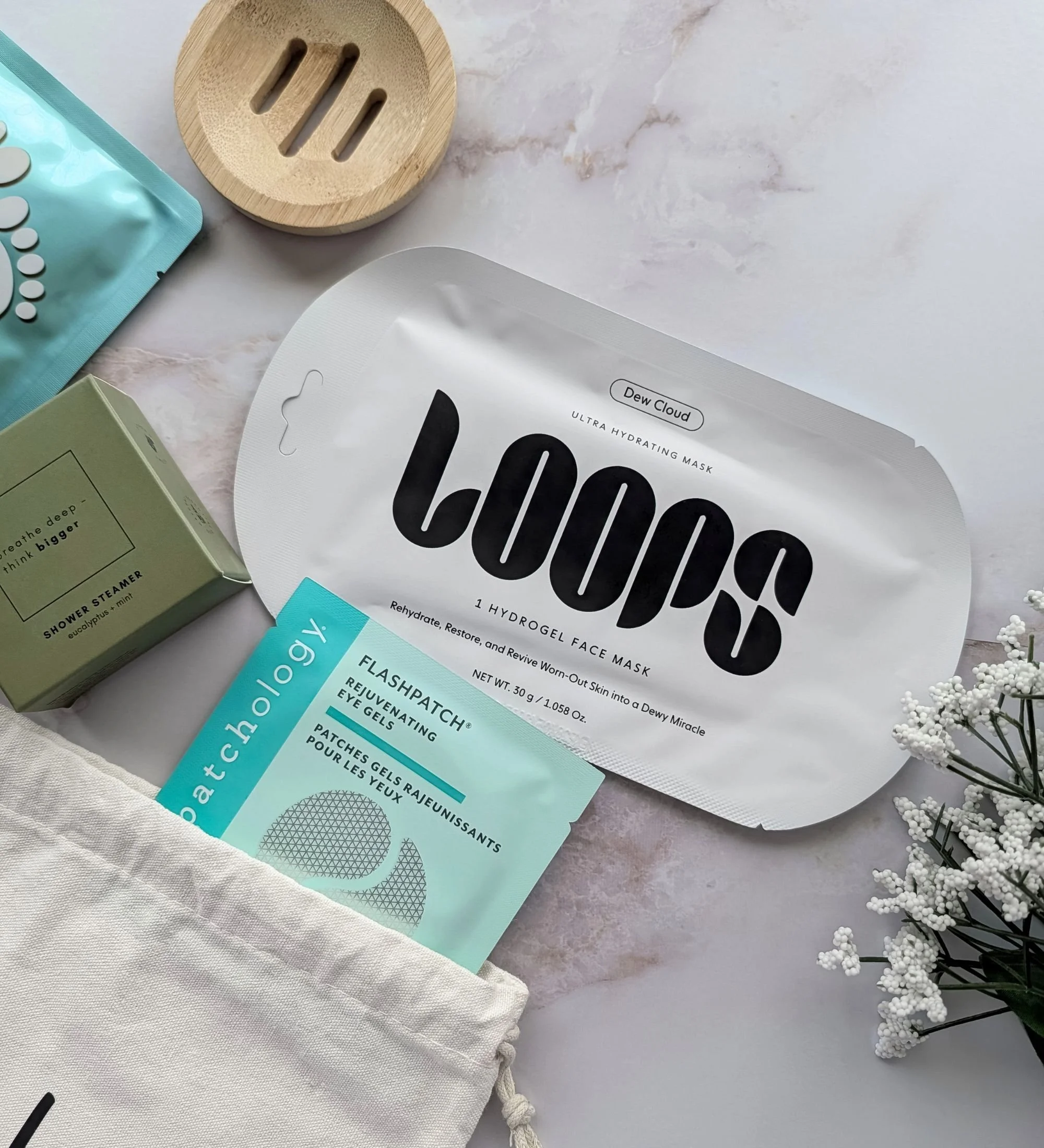 Relaxation self-care gift bundle featuring a hydrogel dew cloud face mask, rejuvenating eye gels, and eucalyptus steamer and bamboo tray.