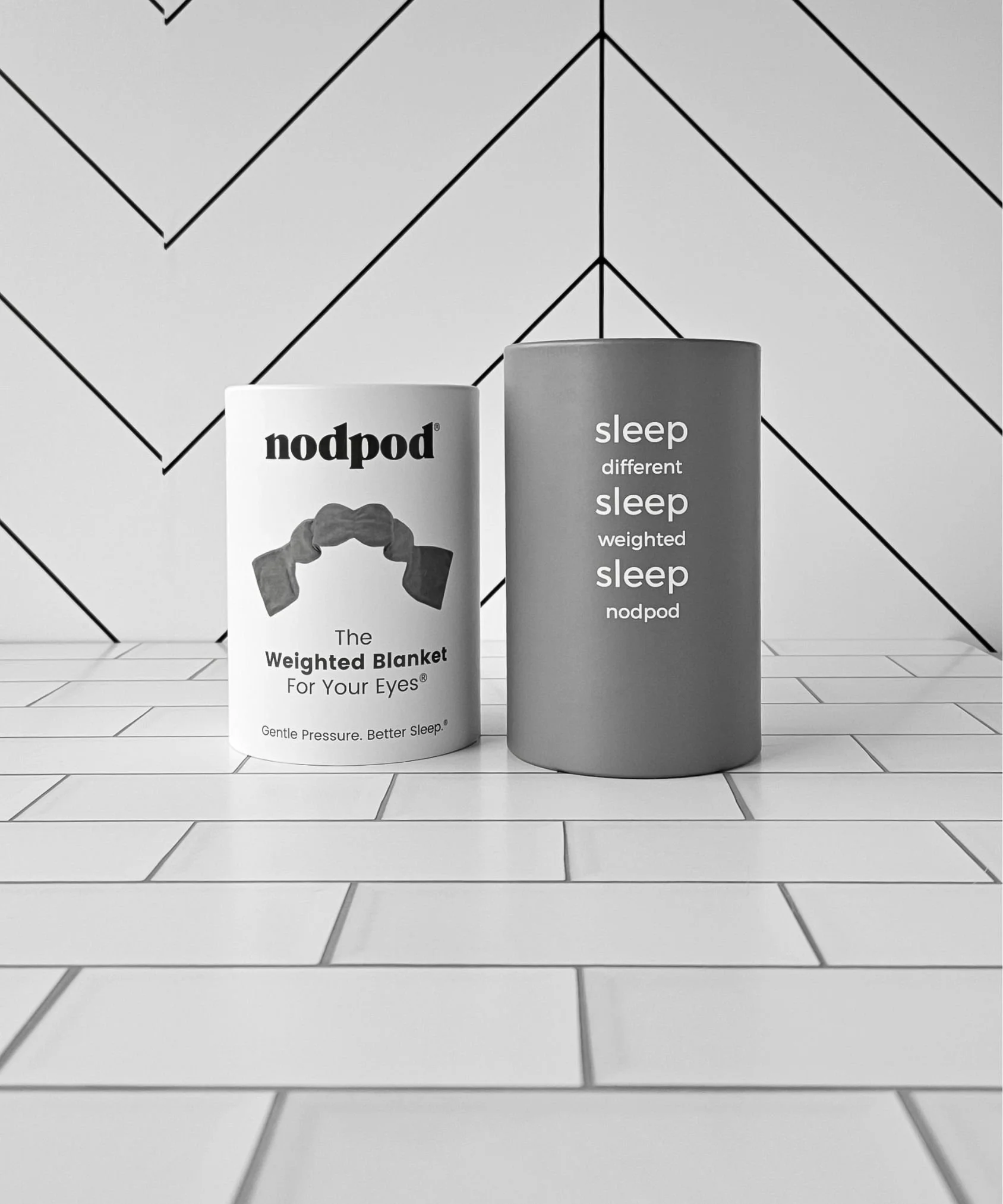 Grey Nodpod weighted eye mask with a strap‑free design that provides stress‑reducing gentle pressure, full light blocking, and deeper, more restorative sleep.