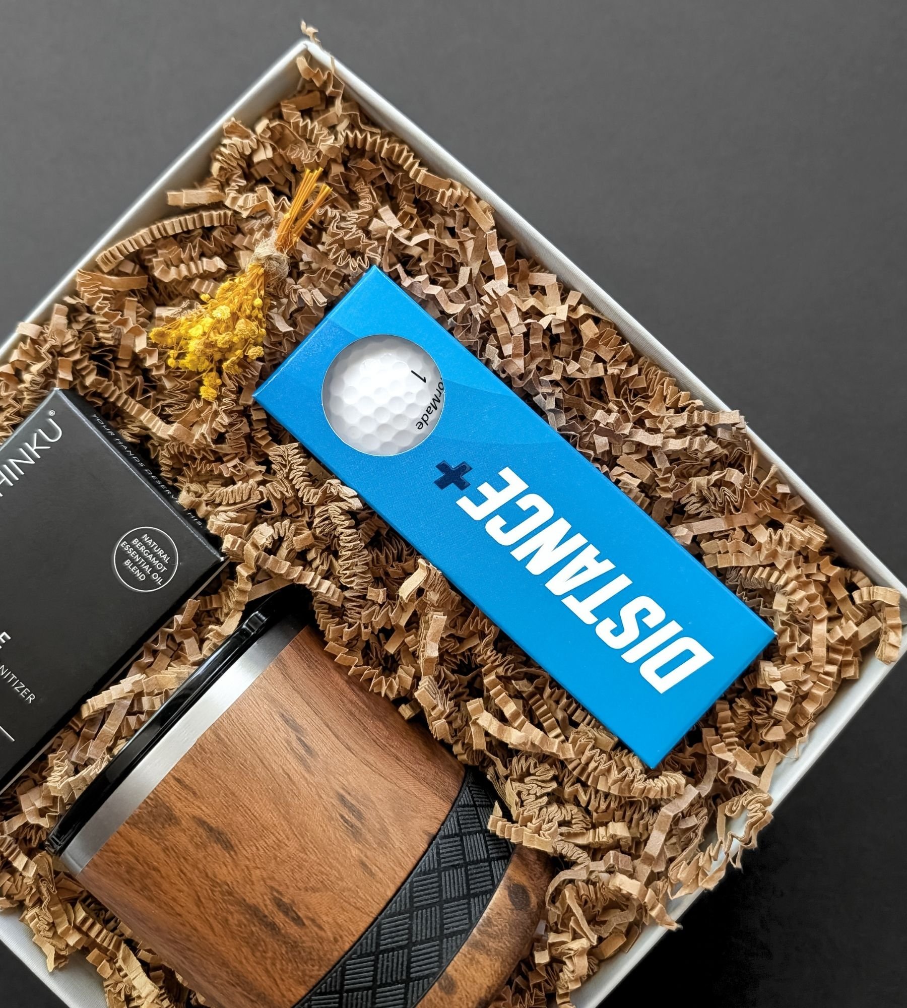 Father’s Day golf gift box with TaylorMade golf balls, bergamot hand sanitizer, and a modern teakwood rocks tumbler.