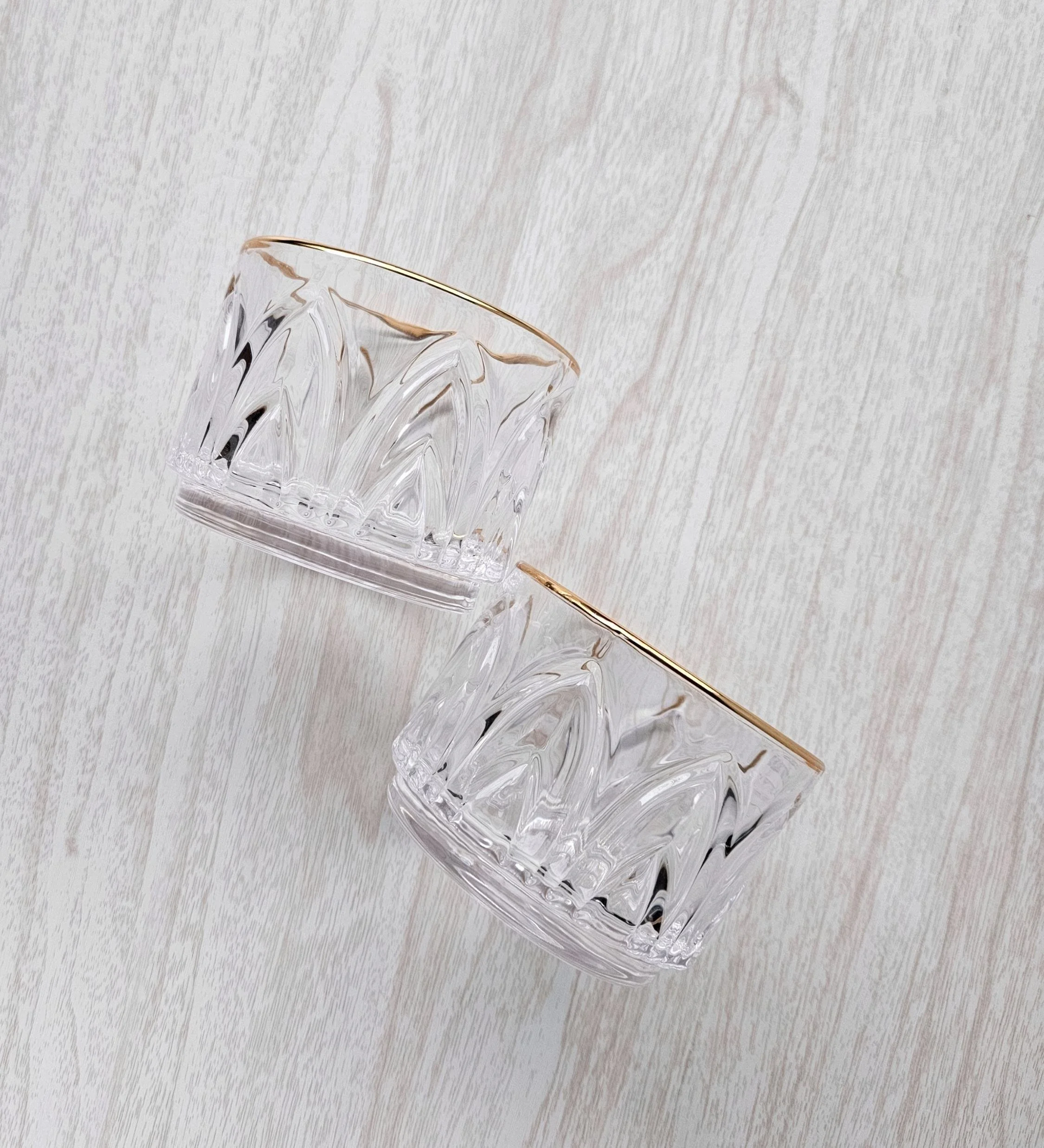 Rose‑tinted negroni glasses with gold rims from The Vow wedding gift box, styled as a romantic bridal gift detail.