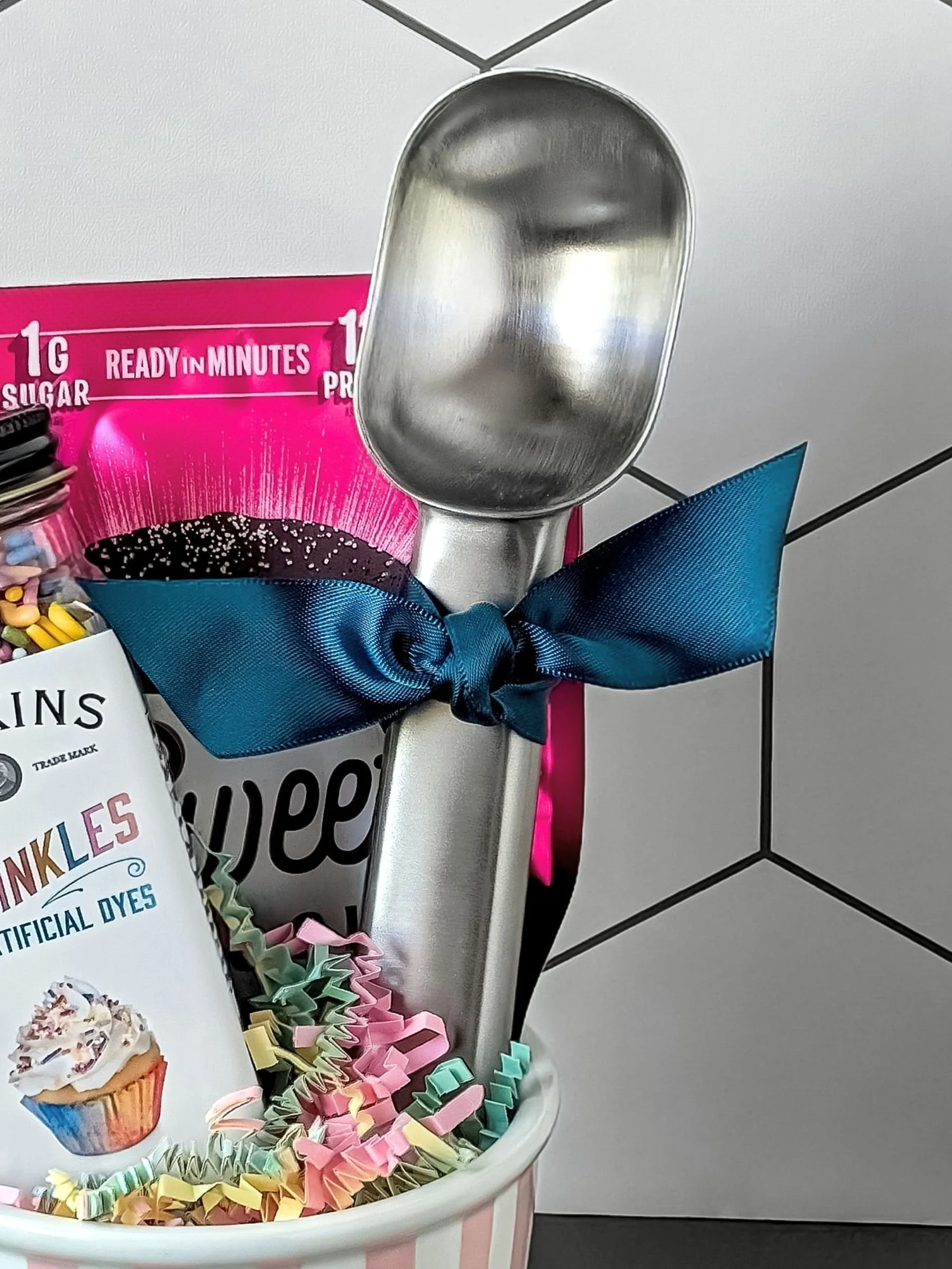 Premium stainless steel ice cream scoop styled with sprinkles and mug cake mix from The Parlor set.