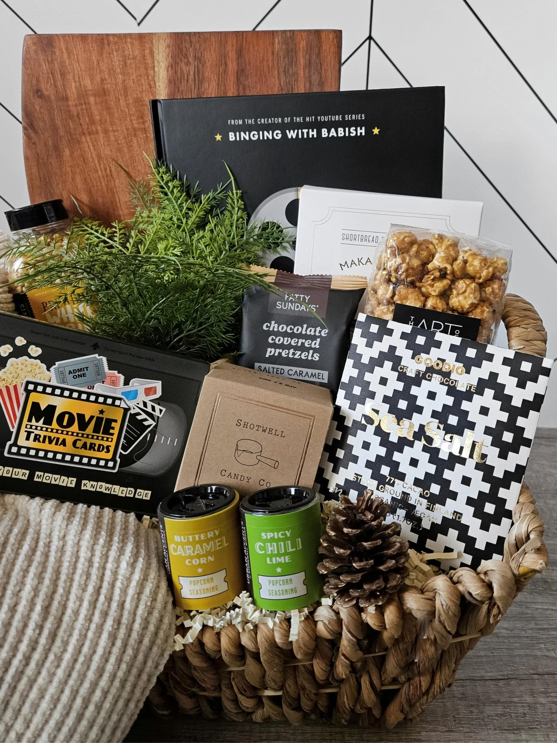 Cozy movie‑night gift box including a plush throw, gourmet popcorn, artisan chocolates, a movie cookbook, and fun trivia for any celebration.