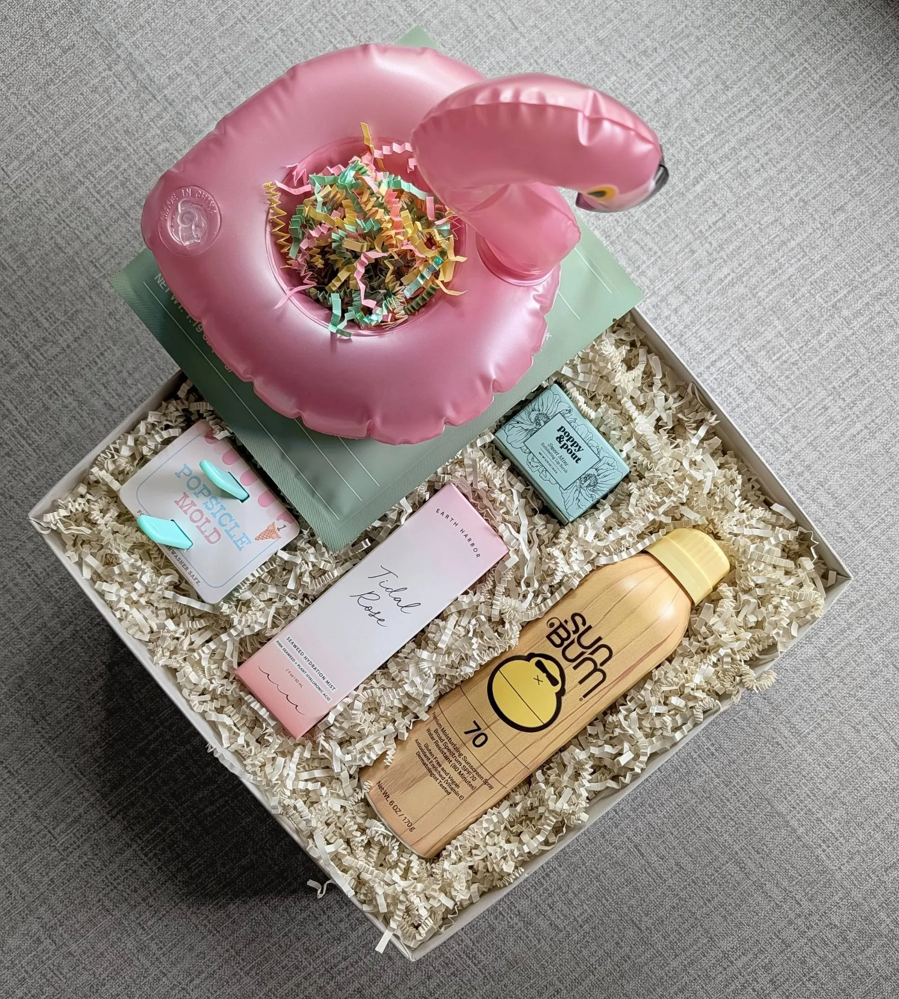 Summer pool‑day gift set with flamingo drink floatie, SunBum SPF, popsicle molds, hydrating facial spray, after sun mask, and a sweet mint lip scrub.