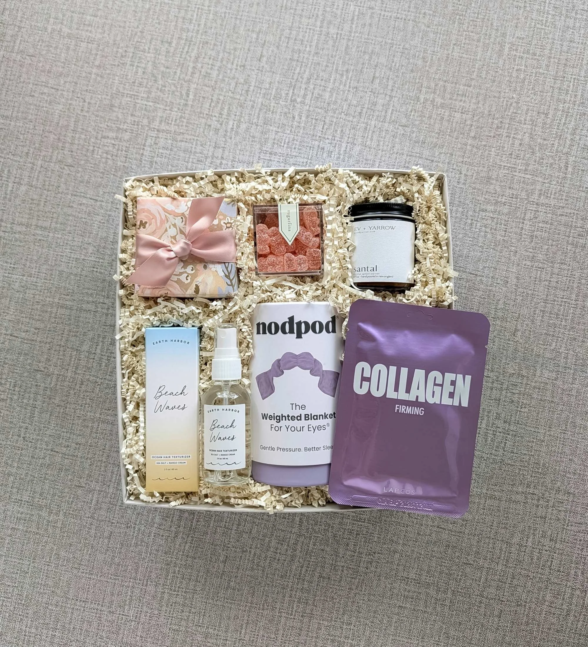 Luxury relaxation gift box for her featuring texture spray, santal candle, weighted eye mask, sheet mask, gummies, and eye patches.