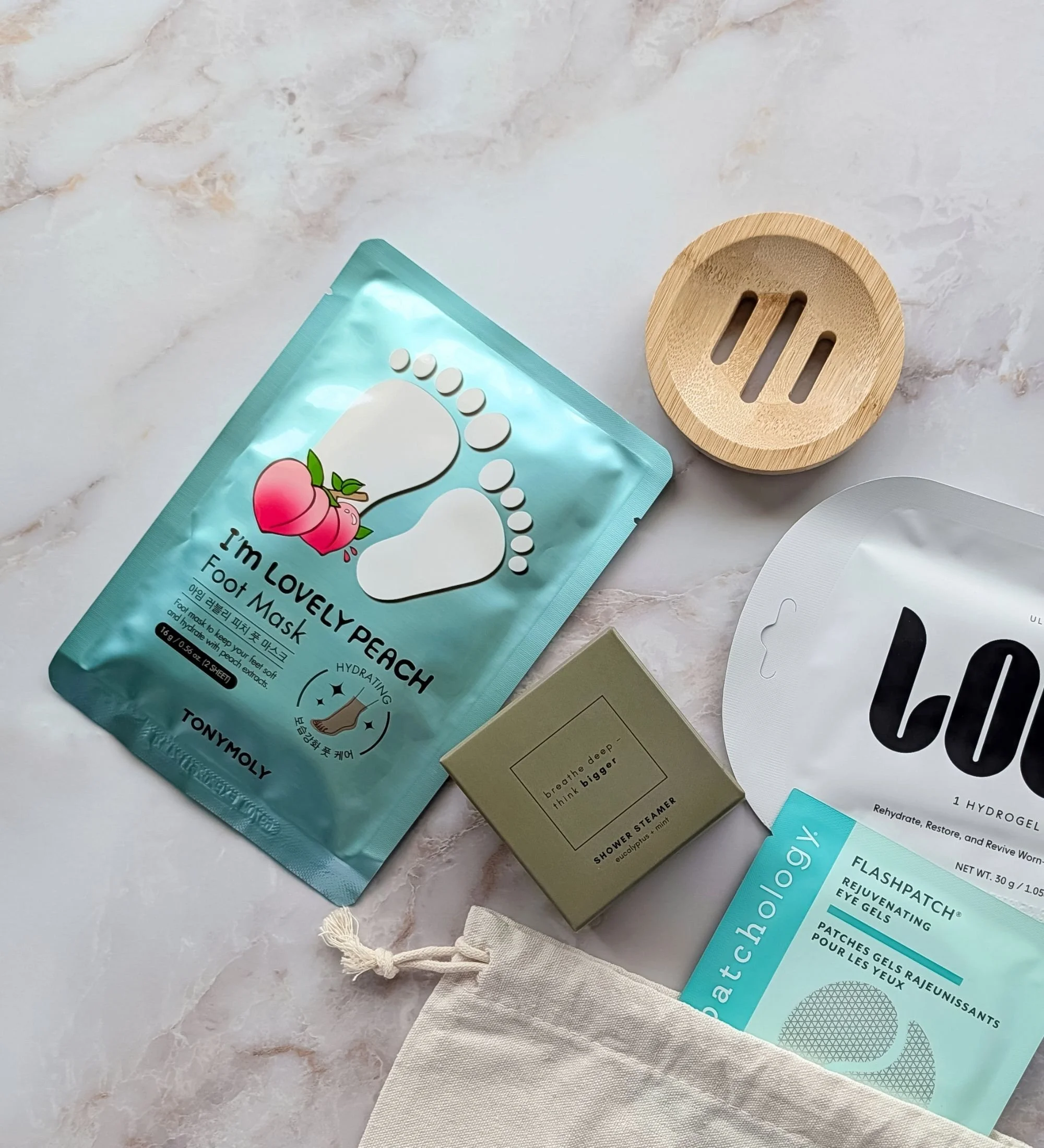 Relax self‑care gift bag with hydrogel face mask, eye gels, peach foot mask, eucalyptus shower steamer, and bamboo tray.