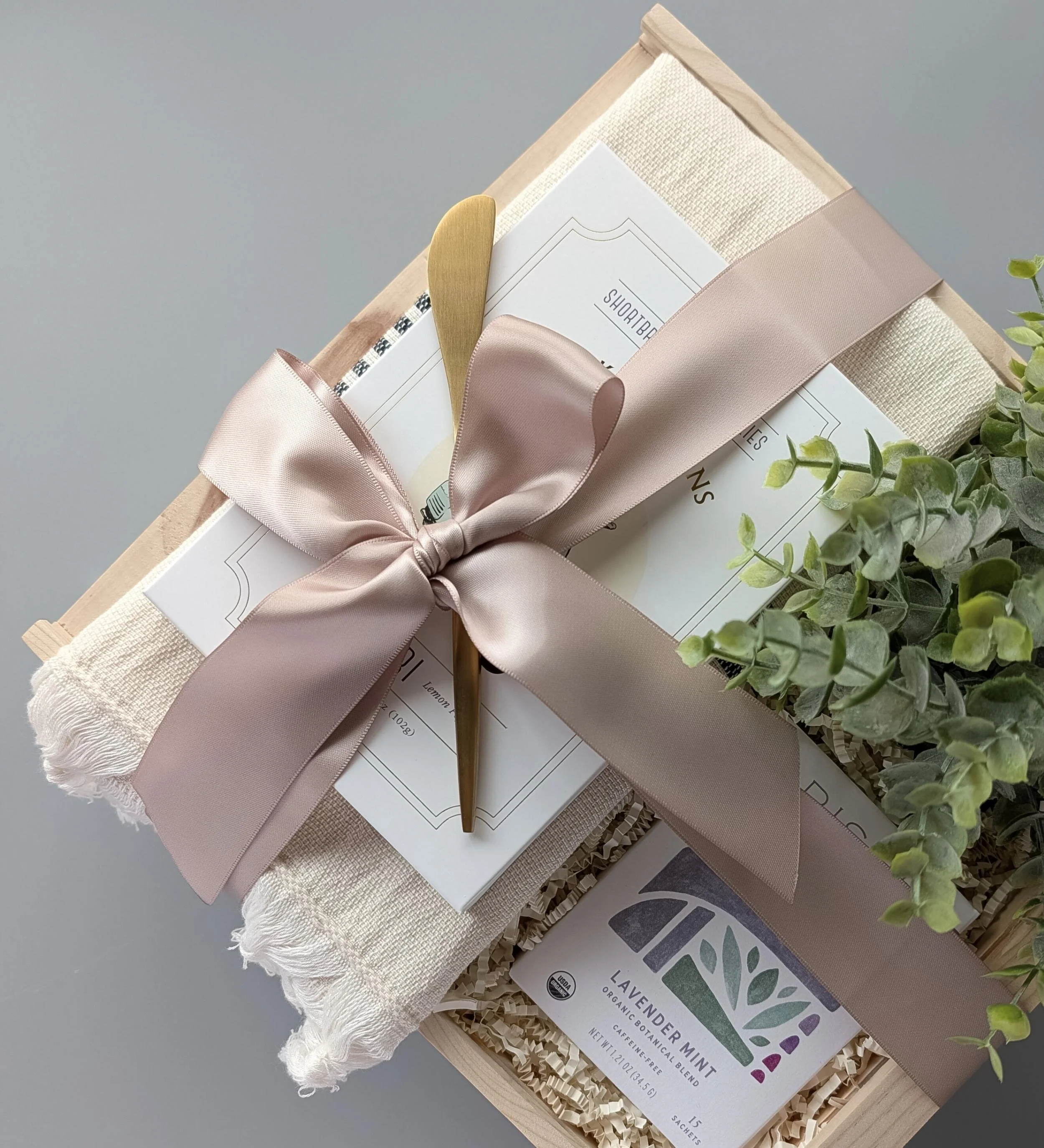Luxury Tea Time basket featuring Rishi Lavender Mint Tea, a large Turkish towel, lemon poppy cookies, and gold accents