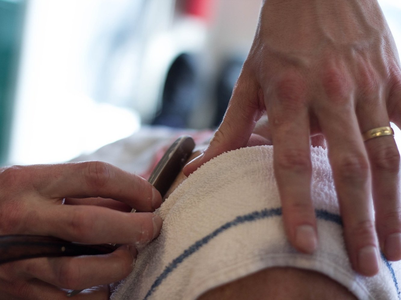 two hands using myofascial scraping tool for massage