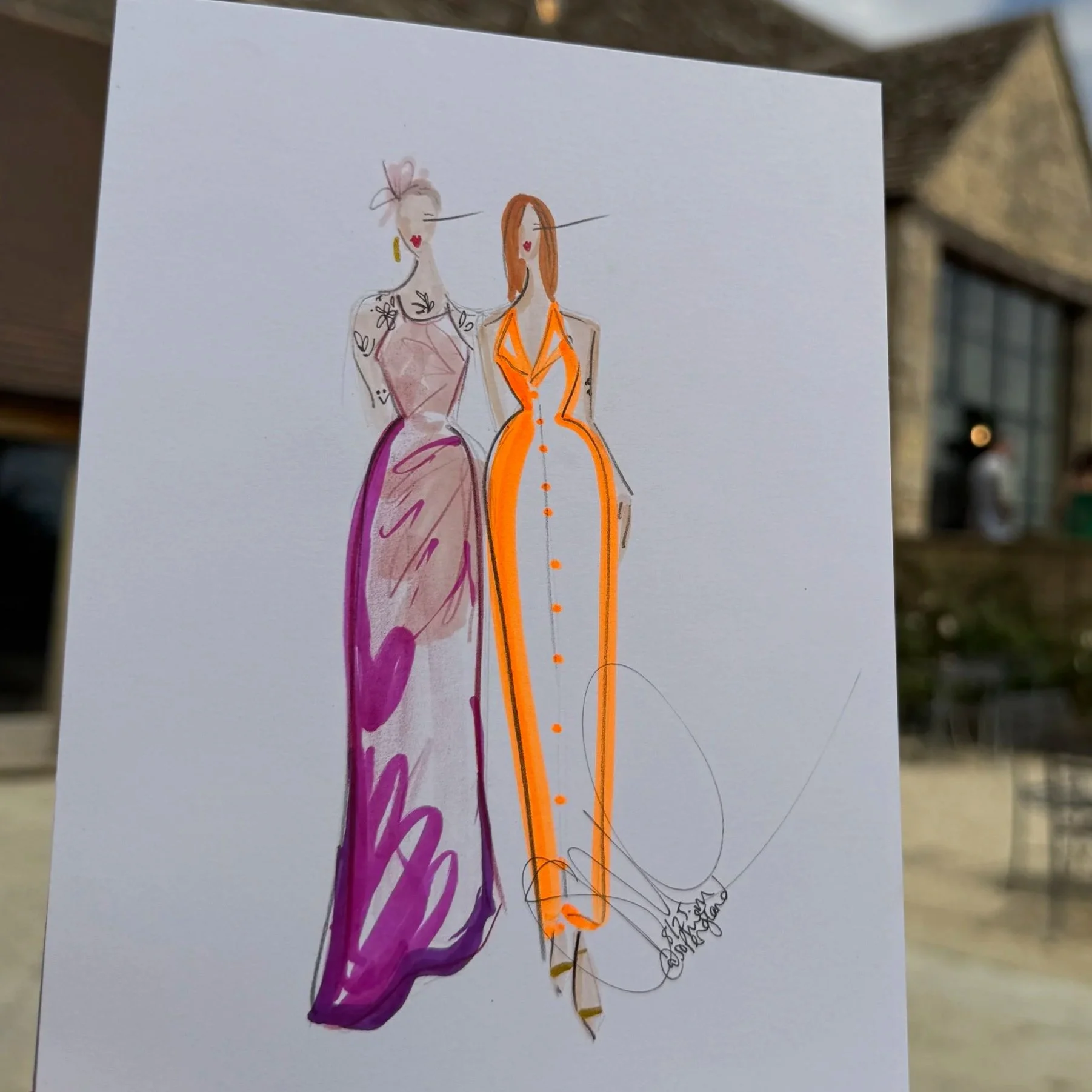 Illustration of two fashionable women in colorful dresses, one with purple and pink and the other with orange, held up outdoors near a stone building and string lights hanging overhead.