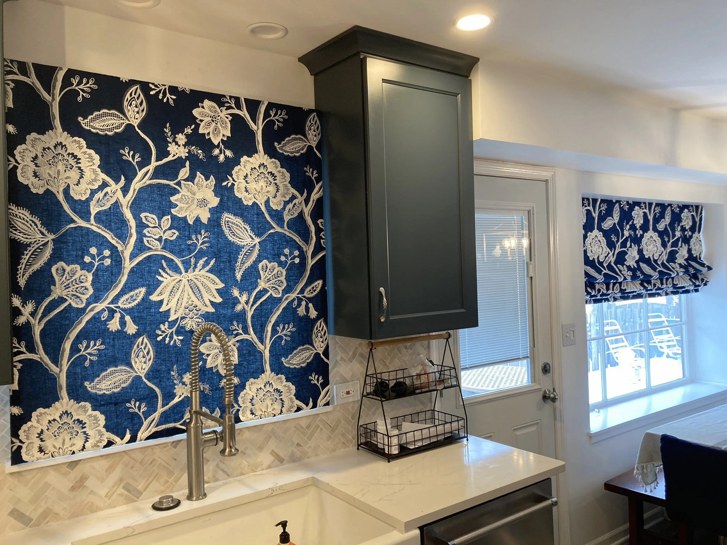 Kitchen interior with bold and beautiful blue and white floral Modern Roman Shades.