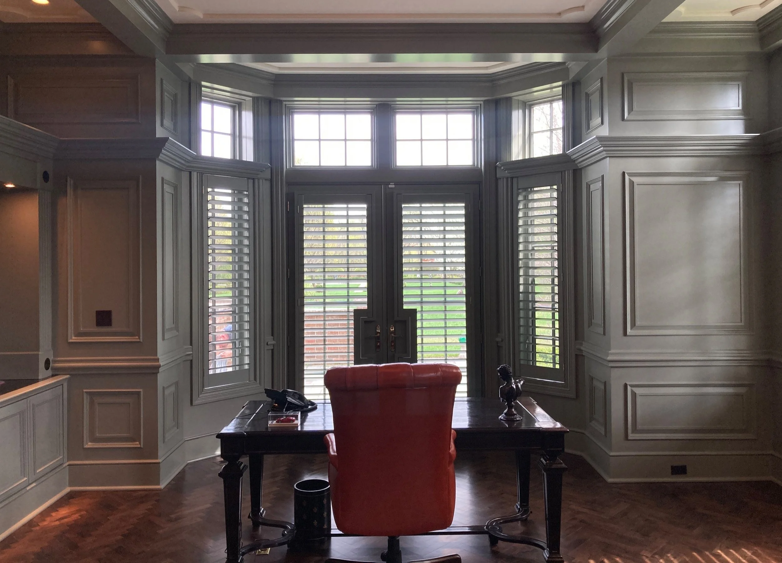 Large windows with gray Wood Shutters in elegant home